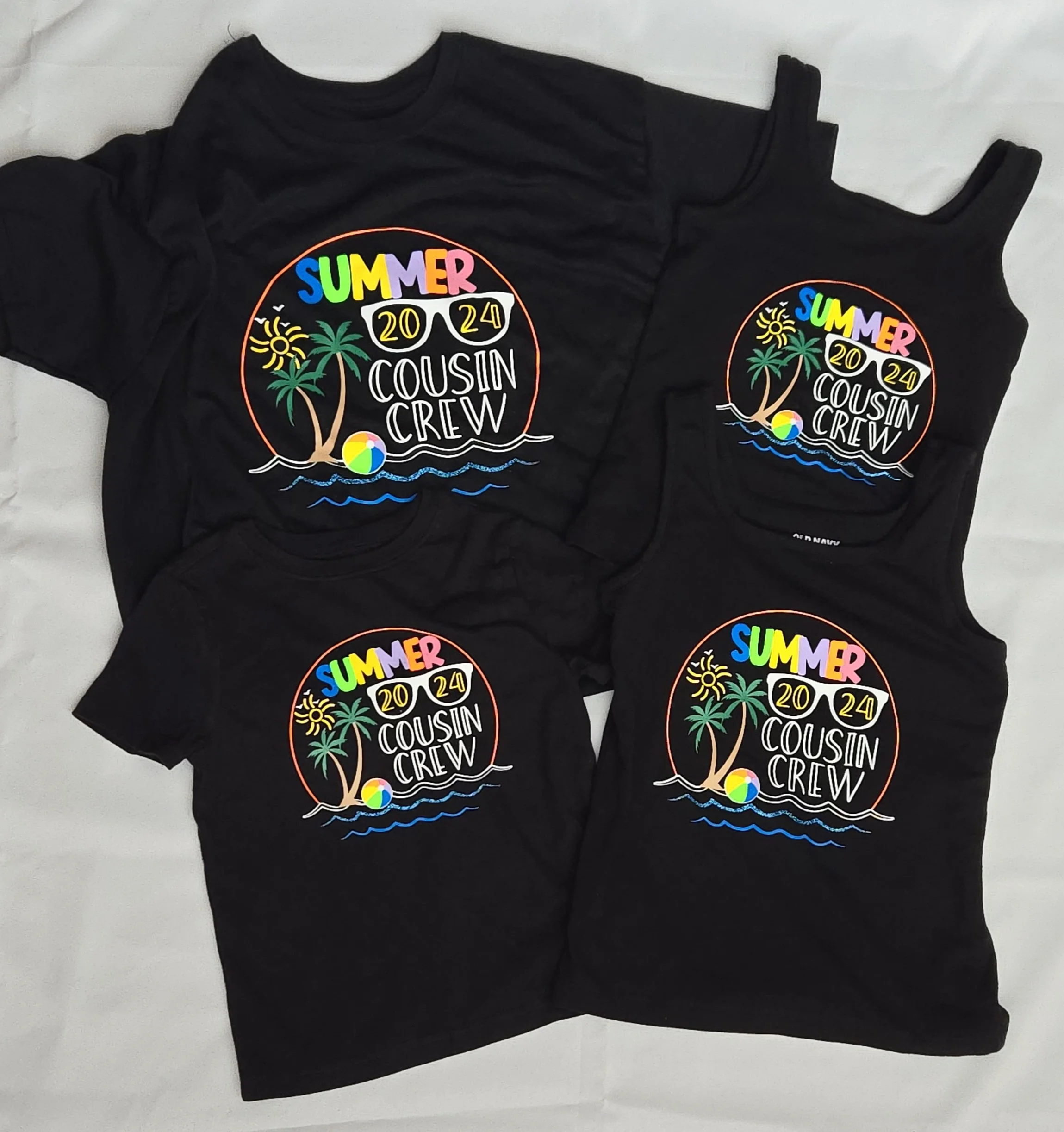 Matching black shirts and tank tops with a colorful Summer 2024 Cousin Crew design with sunglasses and a palm tree