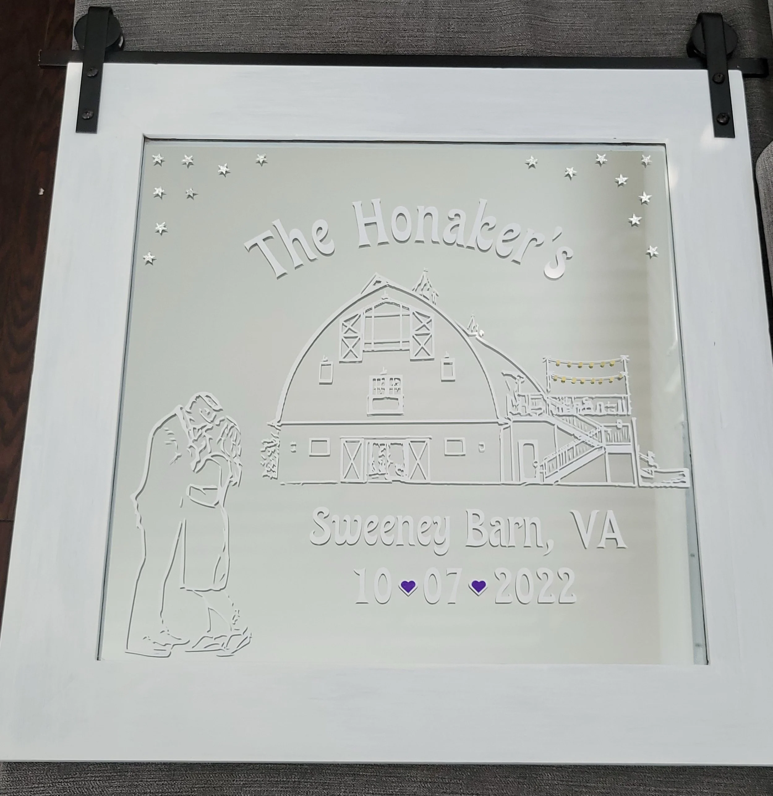 White framed mirror etched with a family name, a couple beside a barn, the Virginia wedding venue, and the wedding date