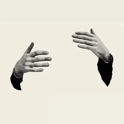 Two black and white hands reaching towards each other with no visible body or background.