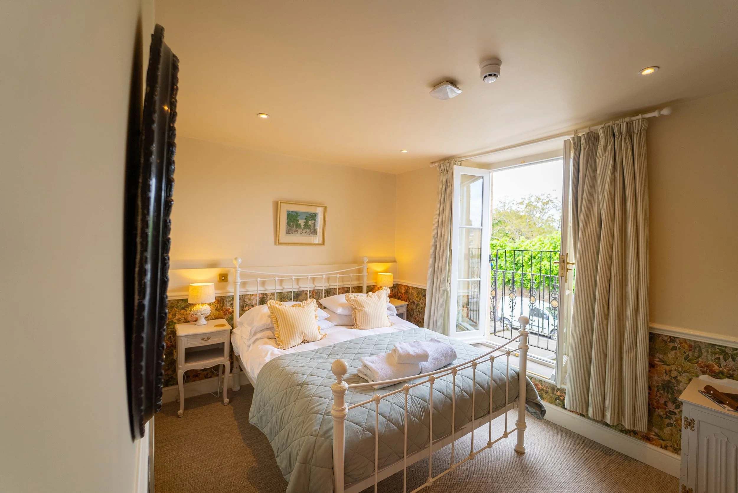 ROOM 2- DESCRIPTION: Room type= Standard Double Room. First floor, floor-to-ceiling opening doors. Located at the front, village facing. King bed, walk-in shower.