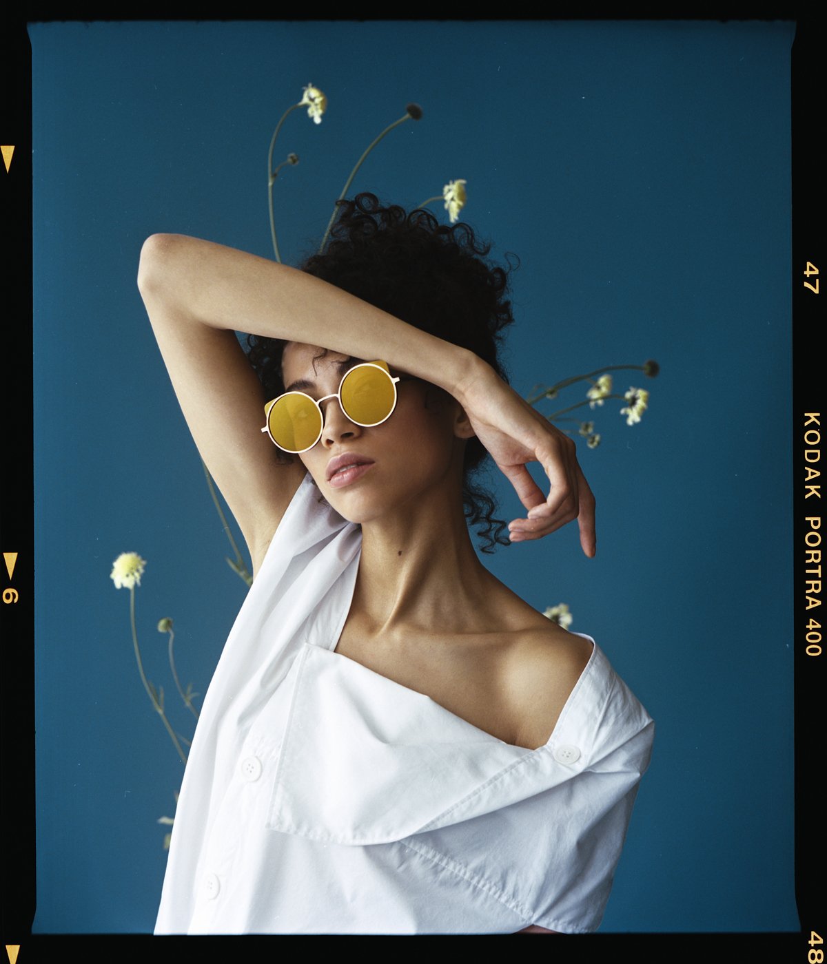 Eyewear campaign: model in yellow sunglasses and an off-shoulder shirt