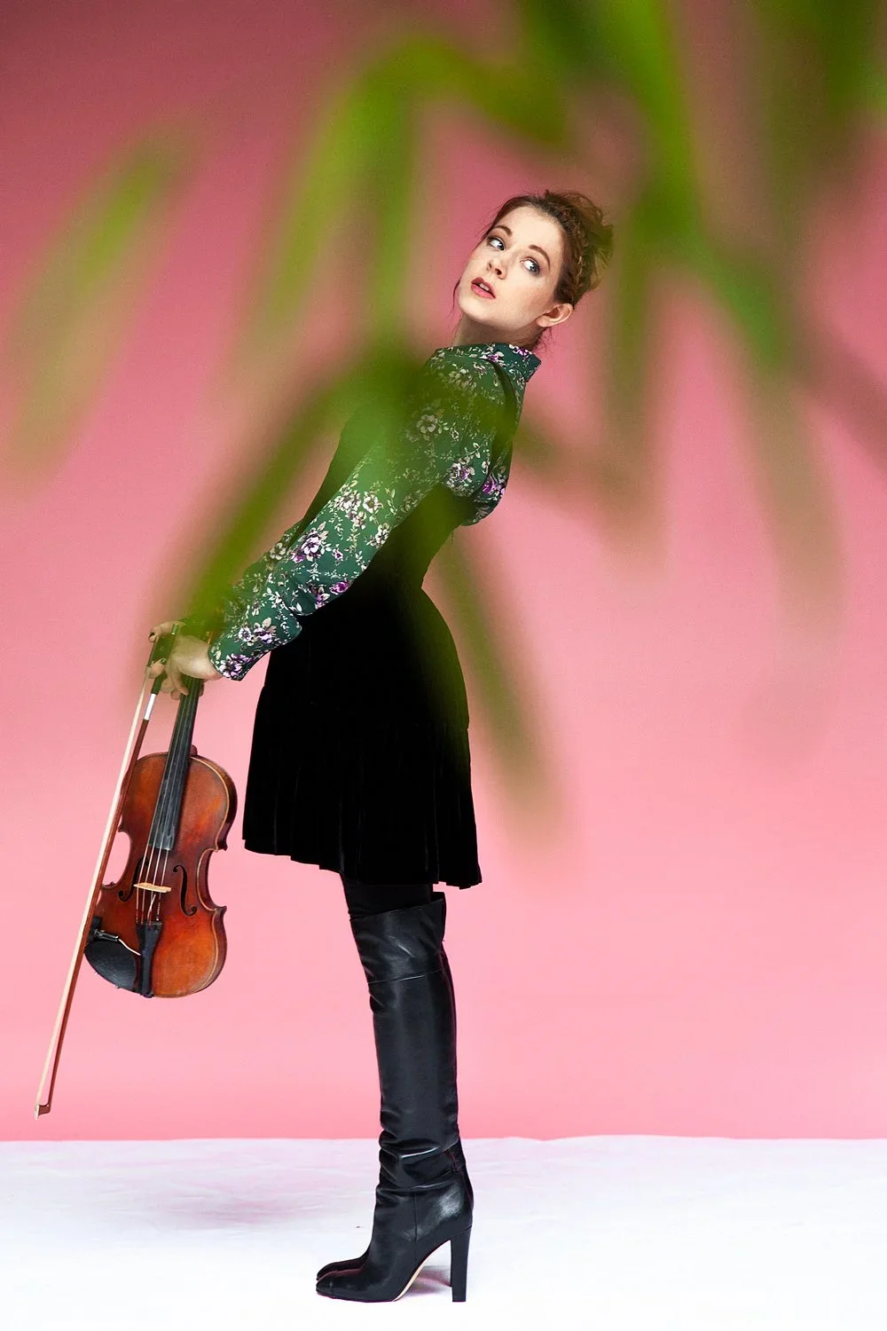 Music press portrait: artist in a floral top and pleated skirt