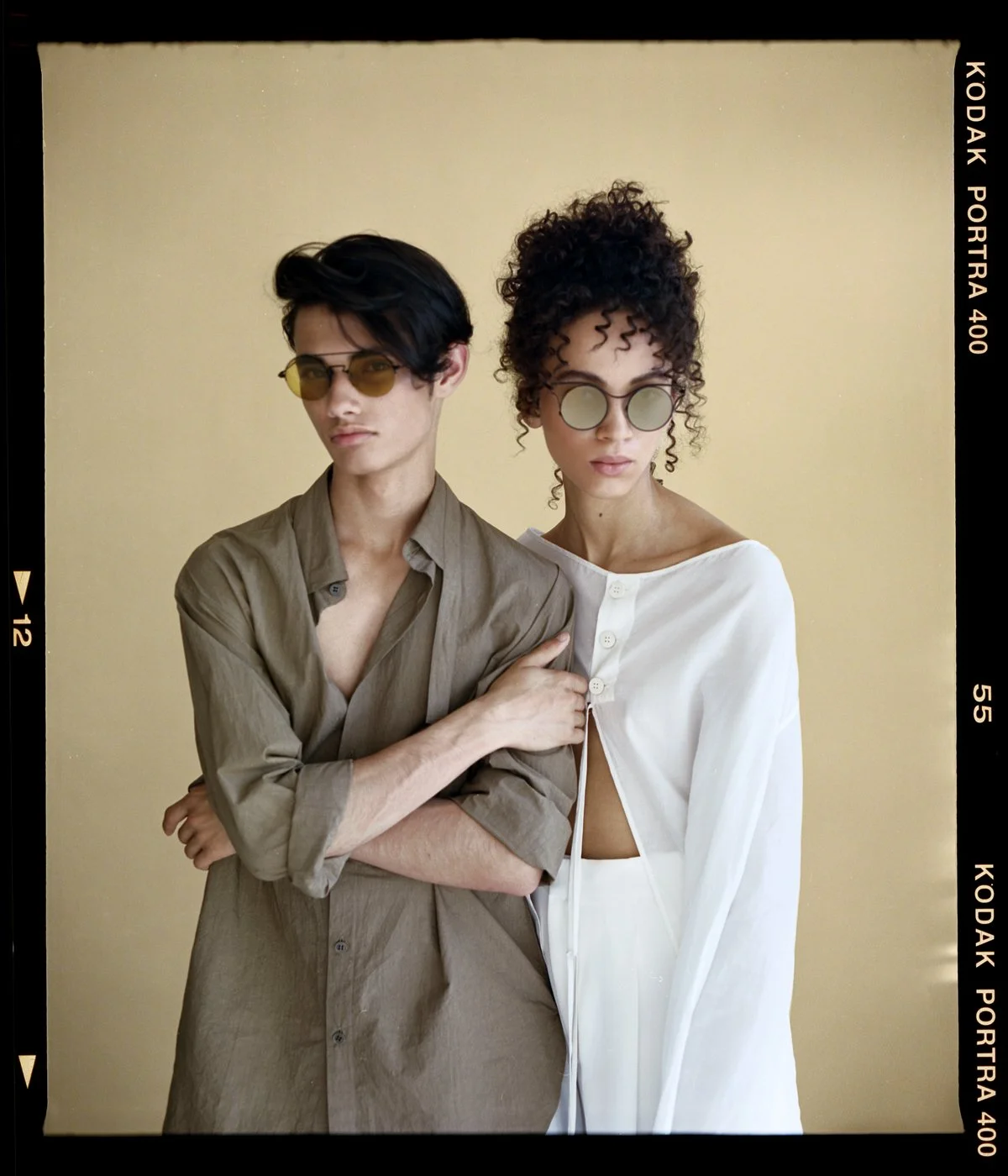 Eyewear campaign: two models in frames against a beige backdrop