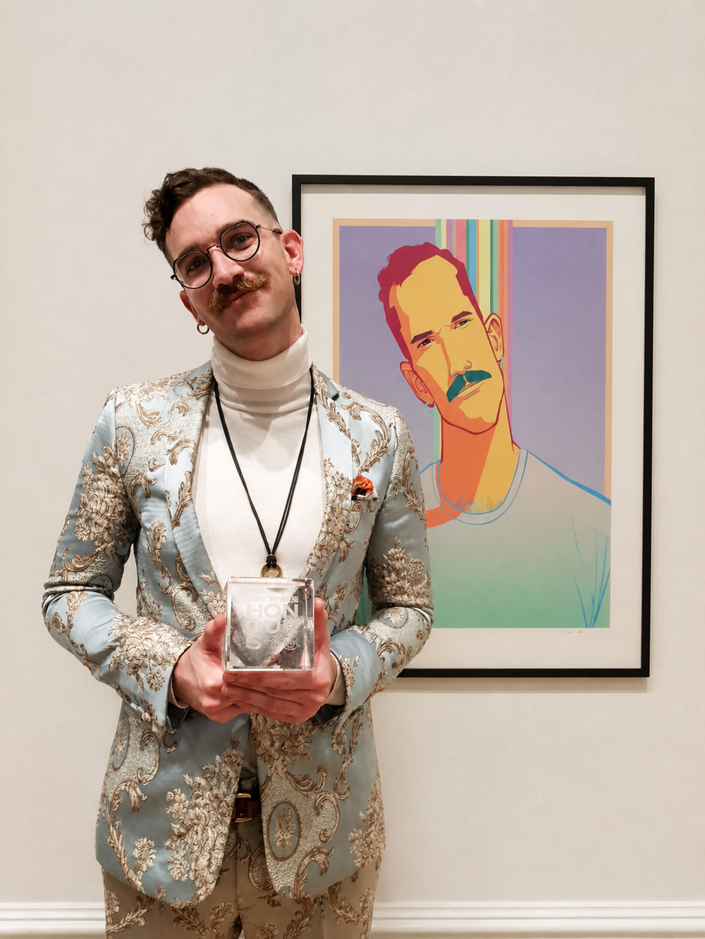Eivind Hansen holding the Gay Times Honour award