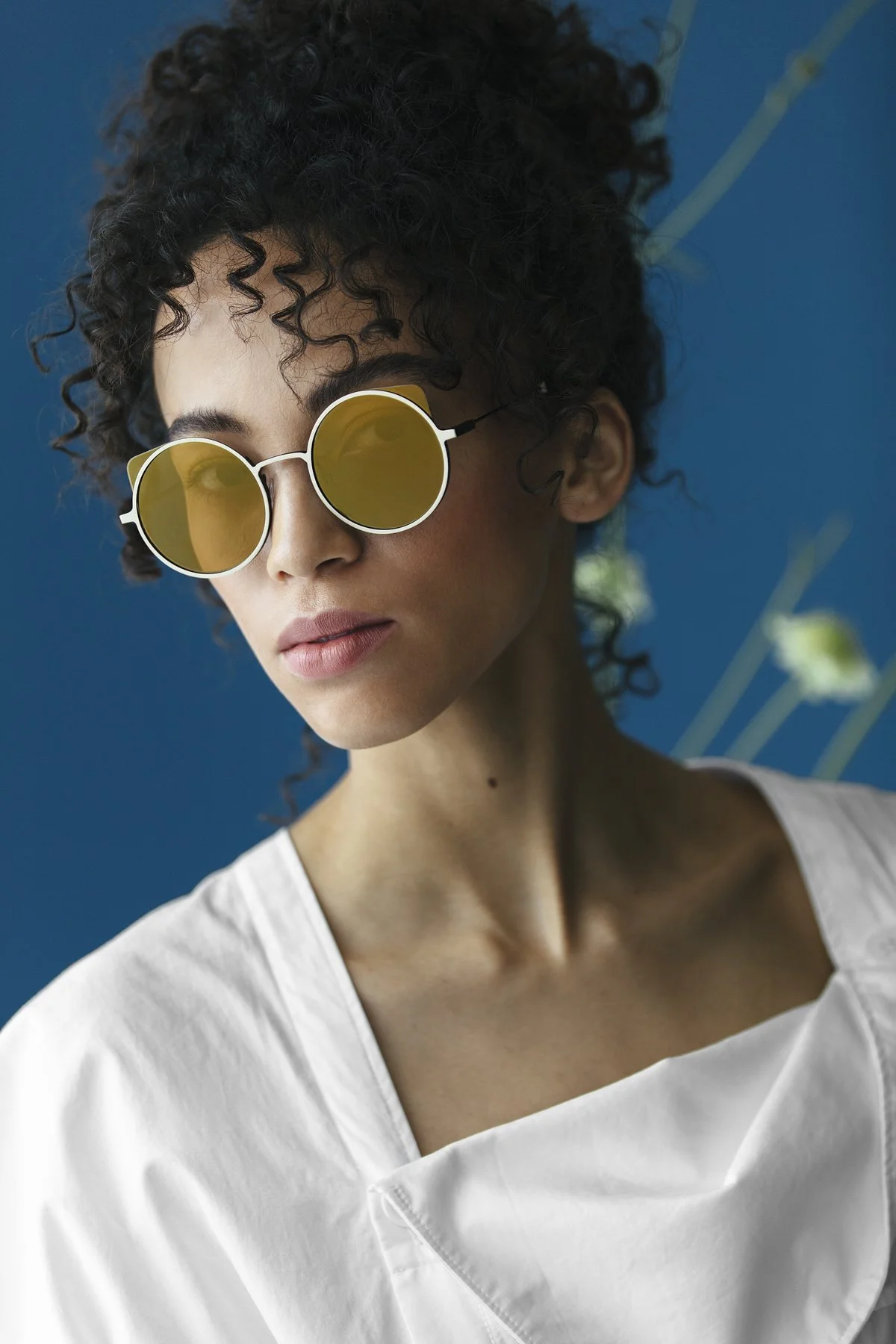 Eyewear campaign: model in yellow-tinted sunglasses and a white top