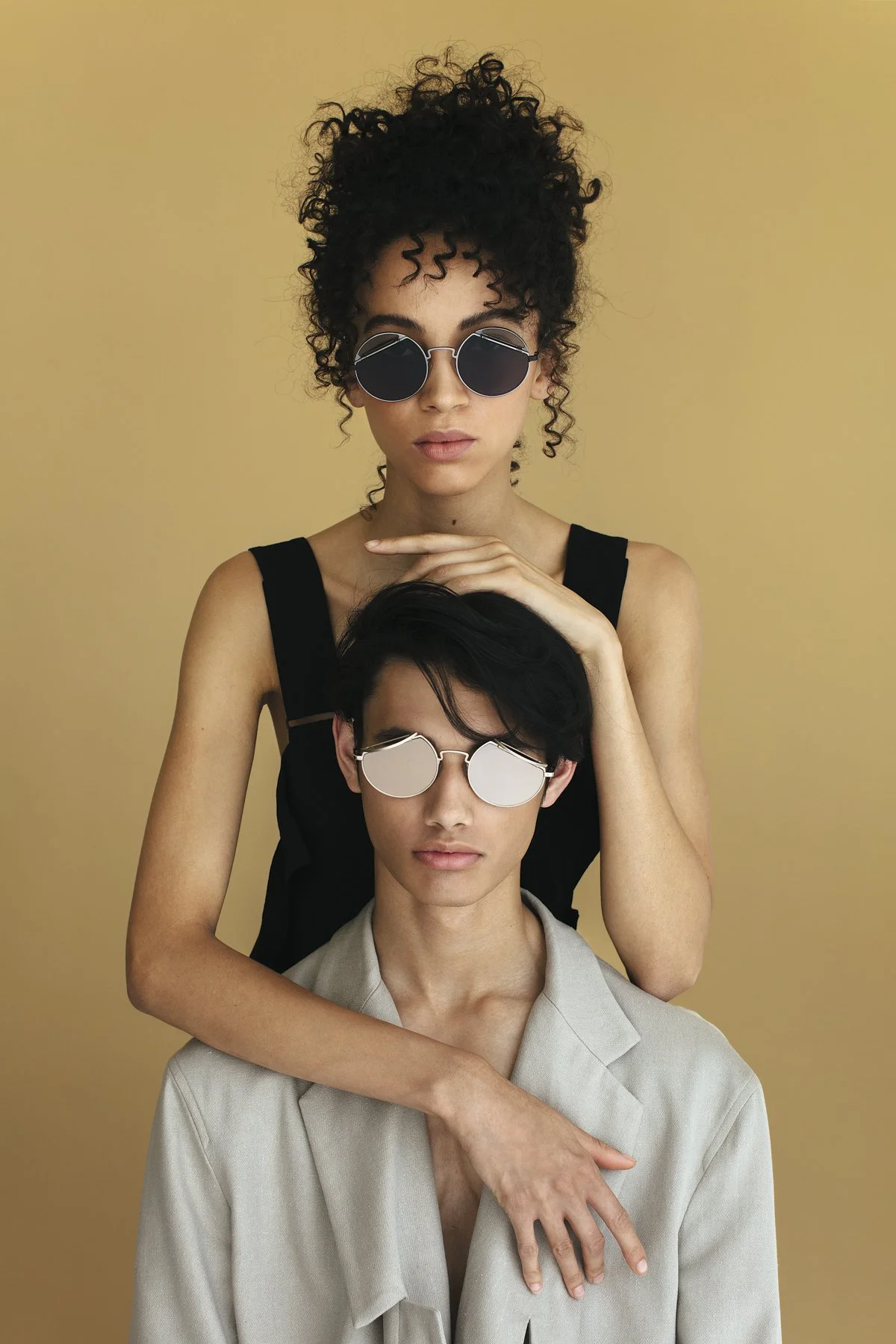Eyewear campaign: two models in black and mirrored sunglasses