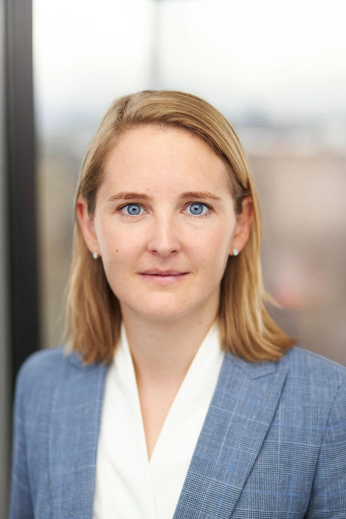 Studio headshot: portrait in a blue blazer and white blouse