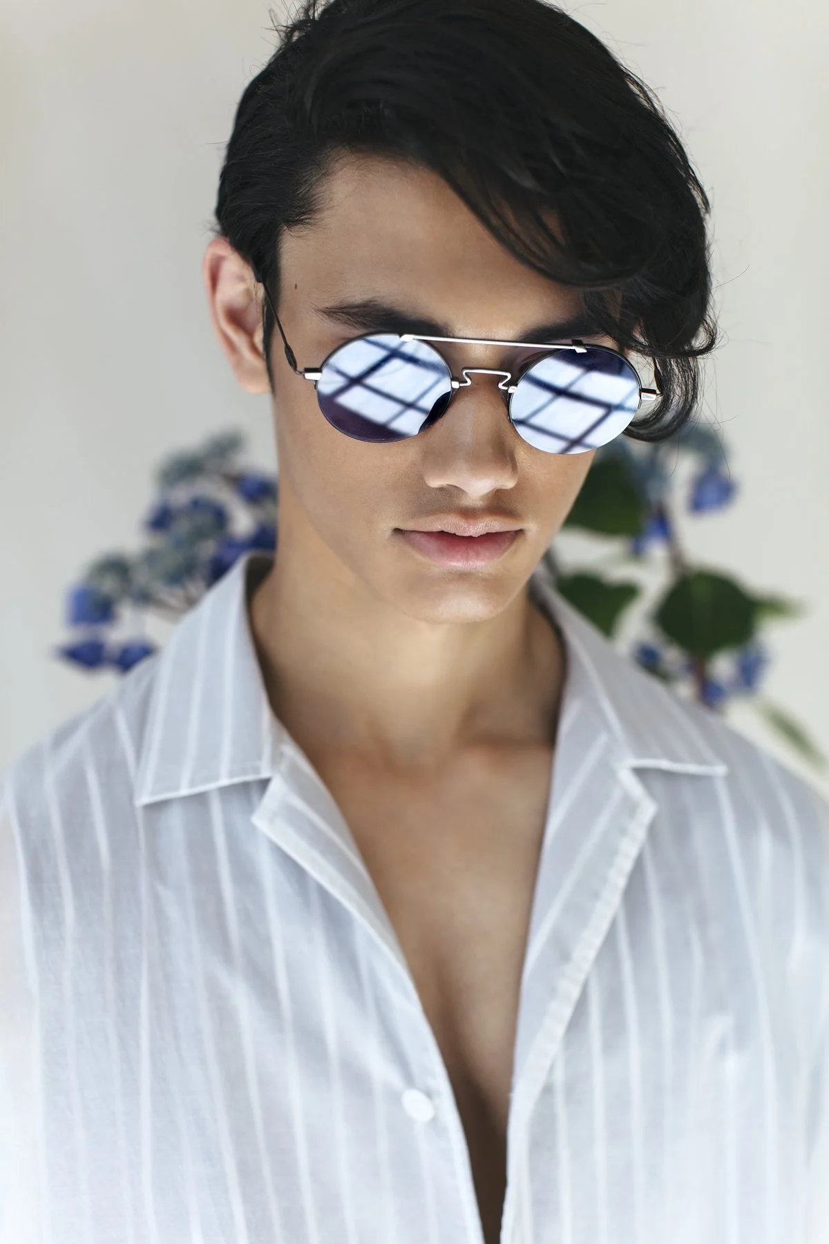 Eyewear campaign: model in mirrored sunglasses and a white shirt