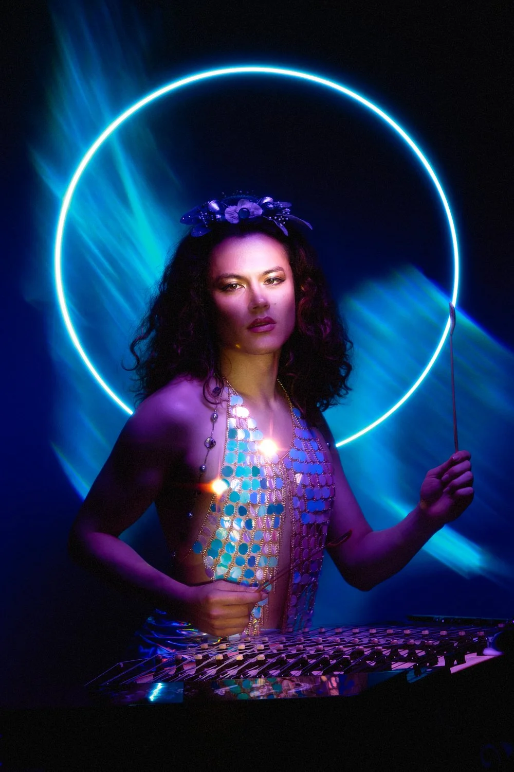Music portrait: artist in a metallic cut-out dress and floral headband