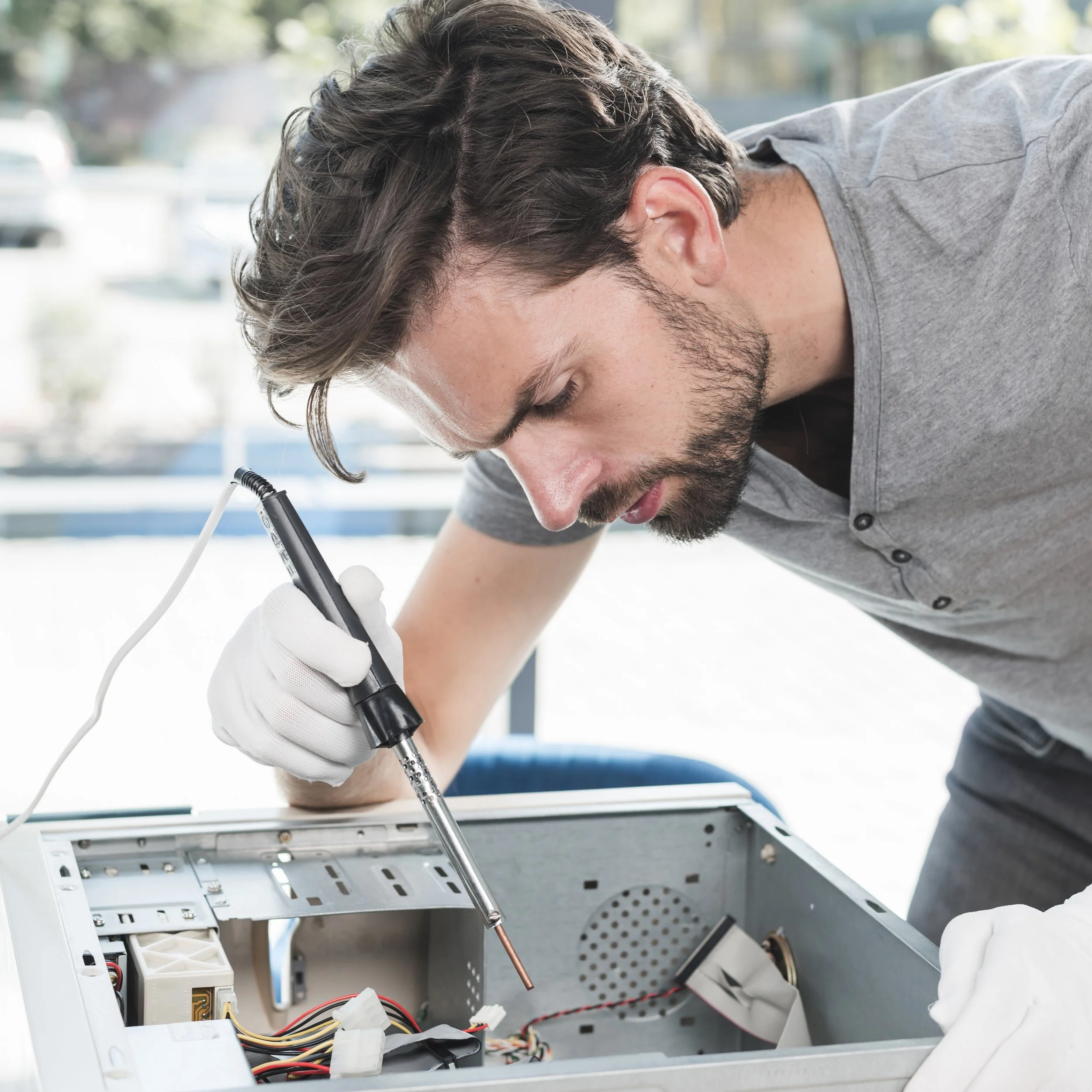 side-view-male-technician-repairing-computer-cpu-workshop.jpg