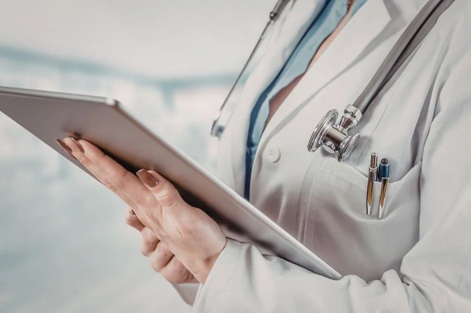 Physician organizing a calendar while managing multi-location QME scheduling in California