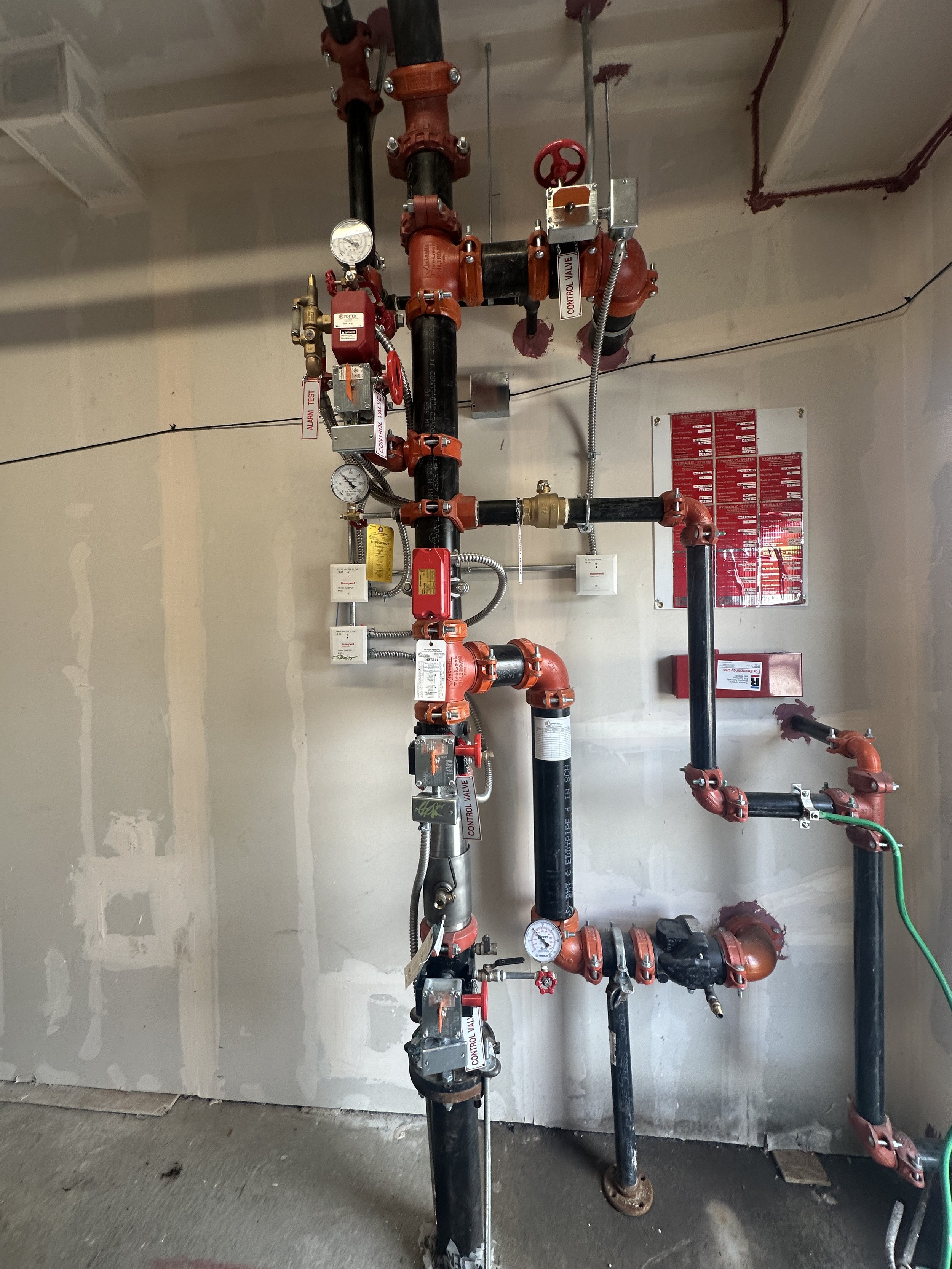 Fire suppression system piping and control valves in a building.