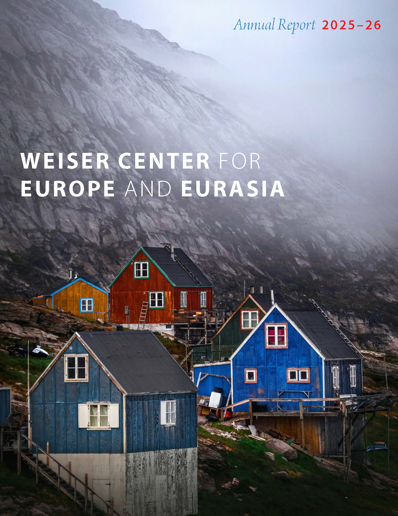 Cover of 2025-26 WCEE Annual Report, with image of colorful yellow, red, and blue houses on the side of a mountain shrouded in fog