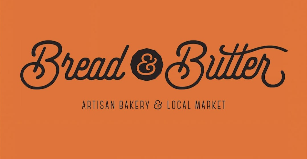 Orange background with black and white text that reads "Bread & Butter Artisan Bakery & Local Market."
