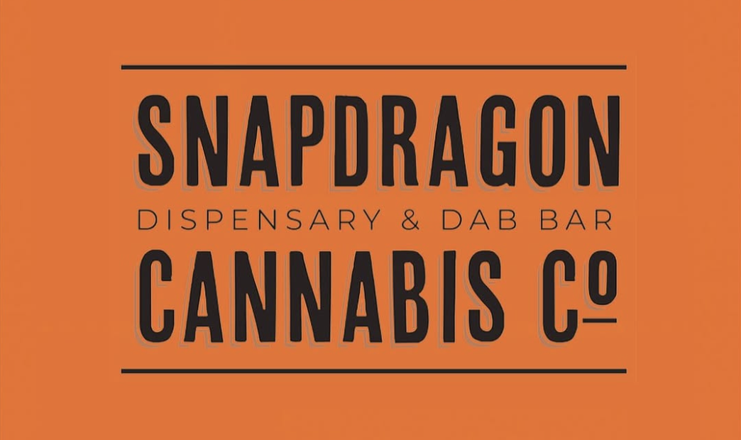 Orange sign for Snapdragon Cannabis Co., dispensary and dab bar.