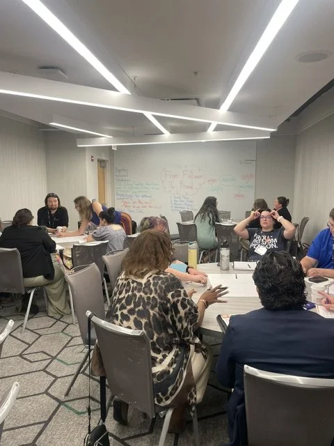 A photo of people sitting around round tables at the AMM 2026 conference