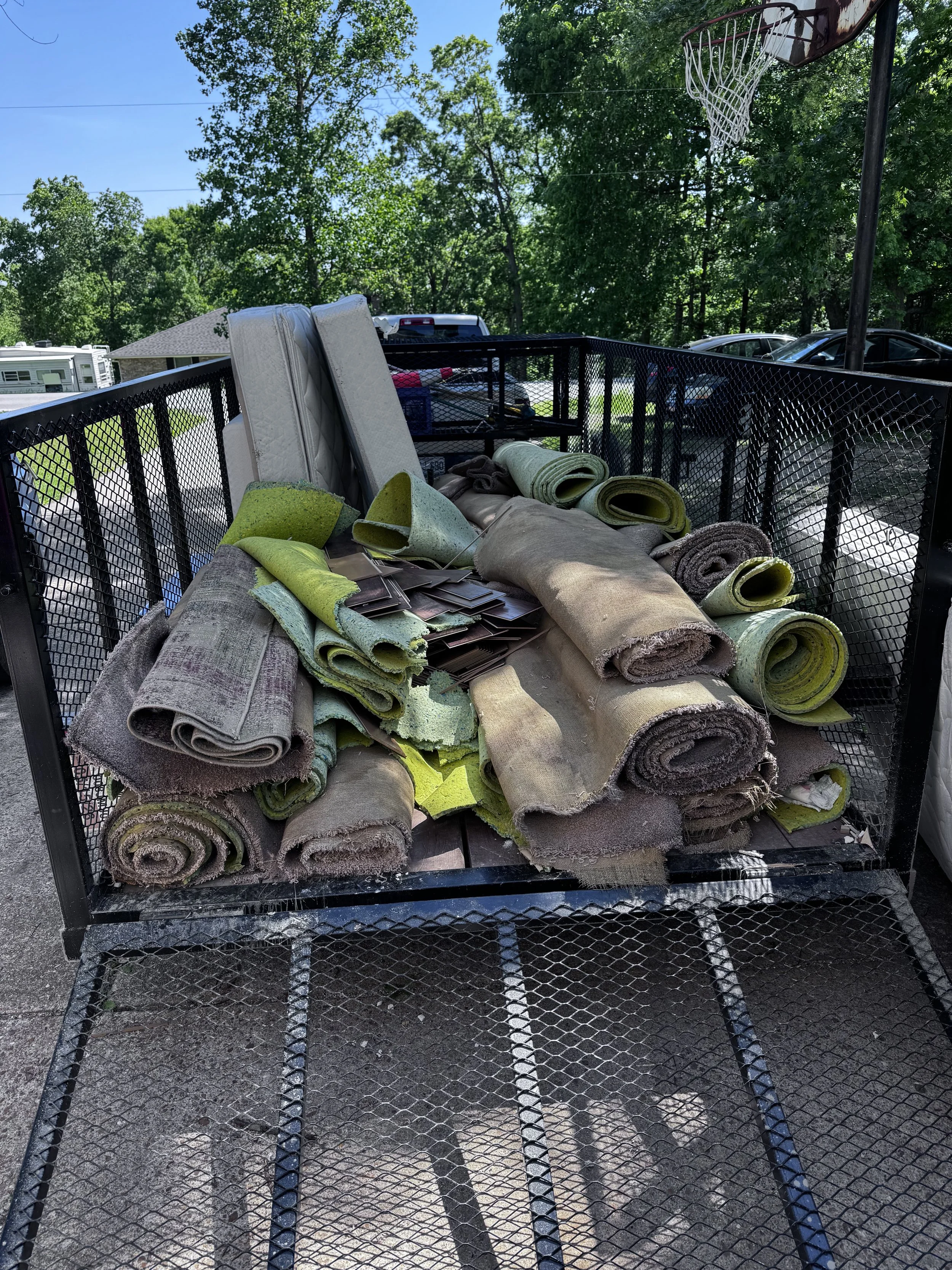 Full carpet removal. Full trailer of hardwood flooring and carpet and carpet padding.