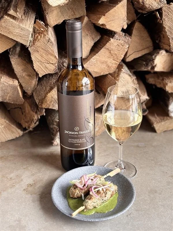 Mint & cilantro pork skewer with a glass of Jackson Triggs 2024 Grand Reserve Sauvignon Blanc
