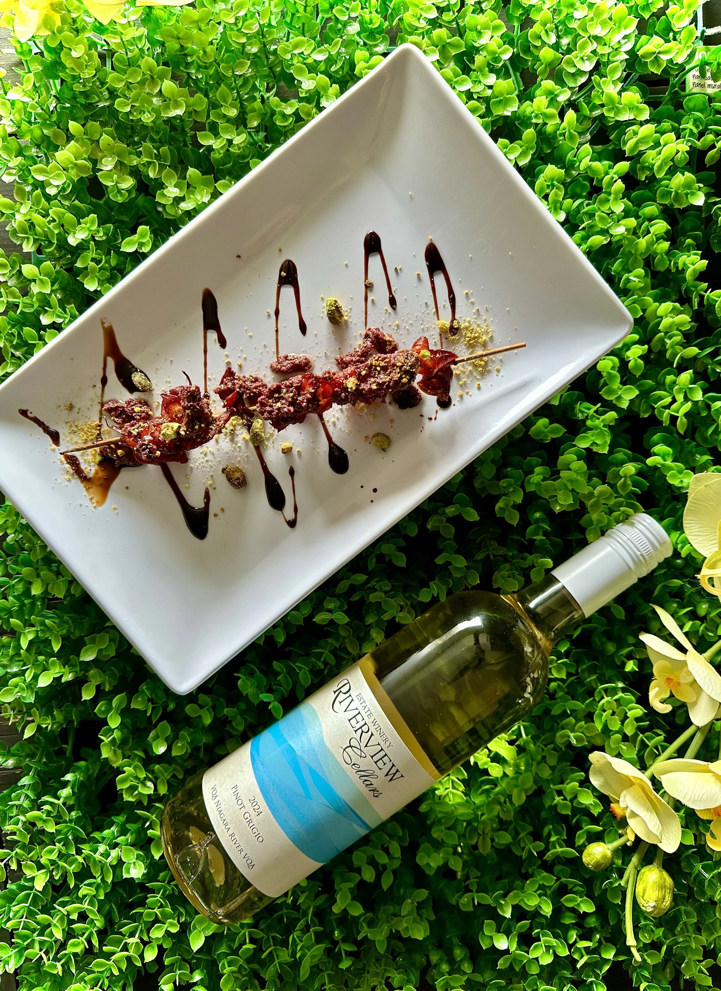 A mortadella skewer and a bottle of Riverview Pinot Grigio