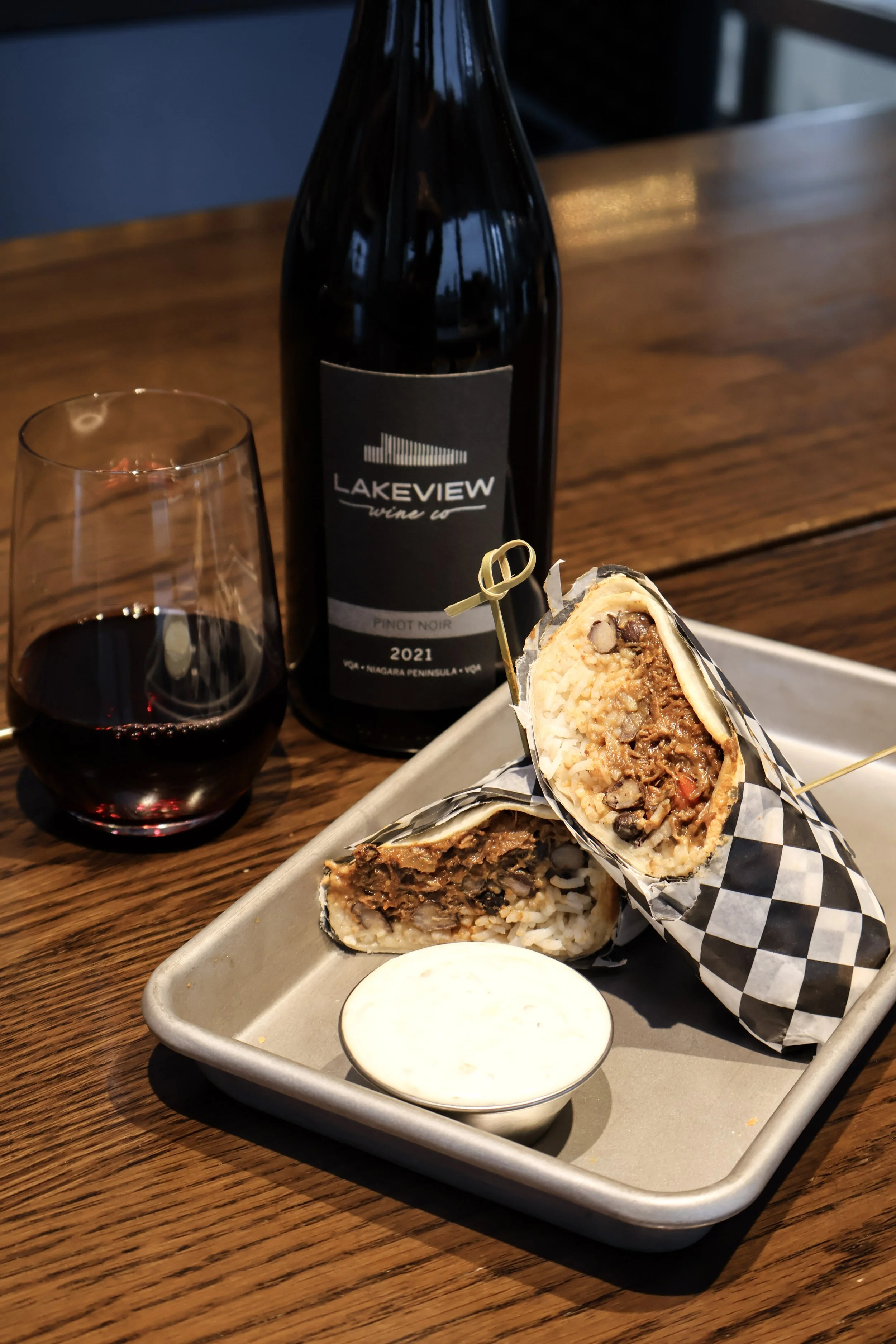 Carnita beef burrito with a glass of Lakeview Pinot Noir