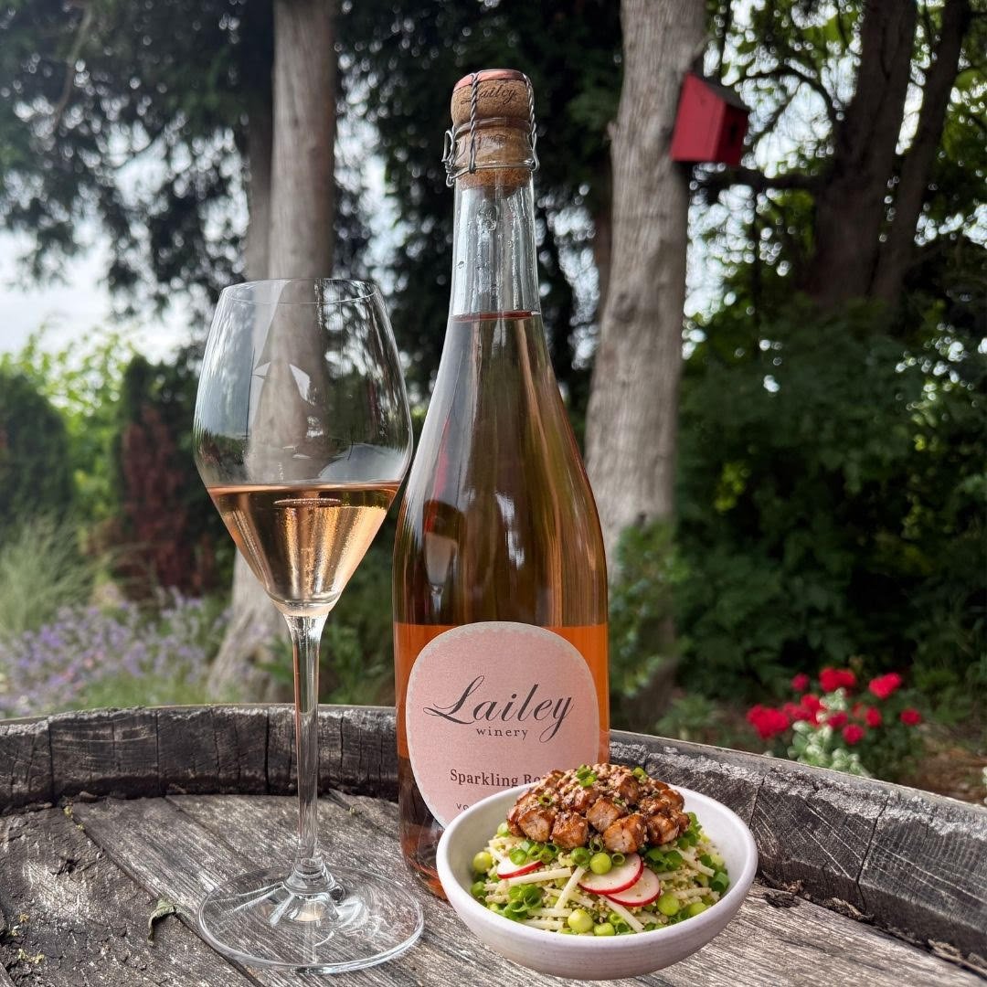 A bowl of lemon grass grilled chicken and a glass of wine from Lailey Winery