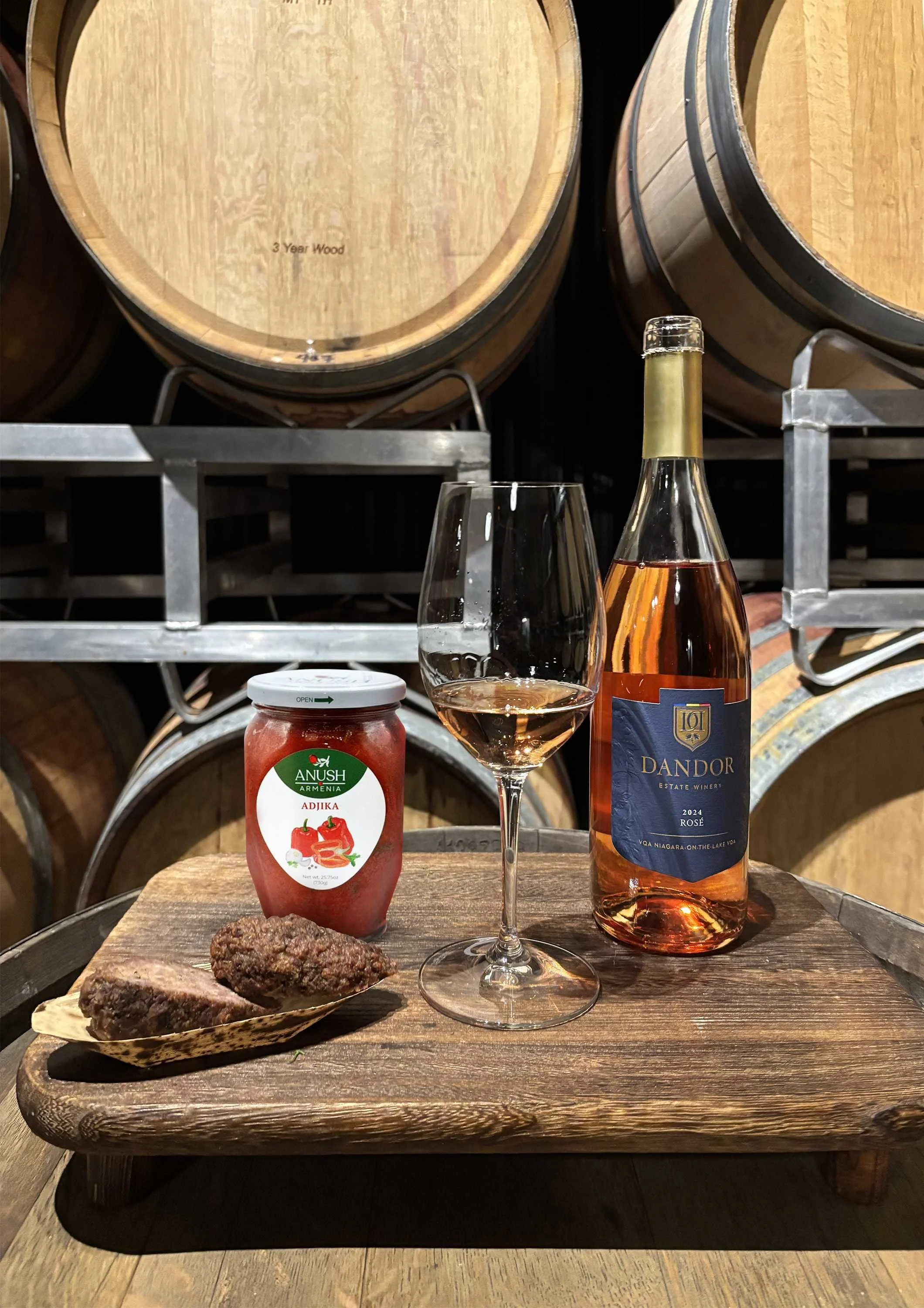 Traditional grilled sausages and a bottle of Dandor Estate Rose wine and a glass of the rose