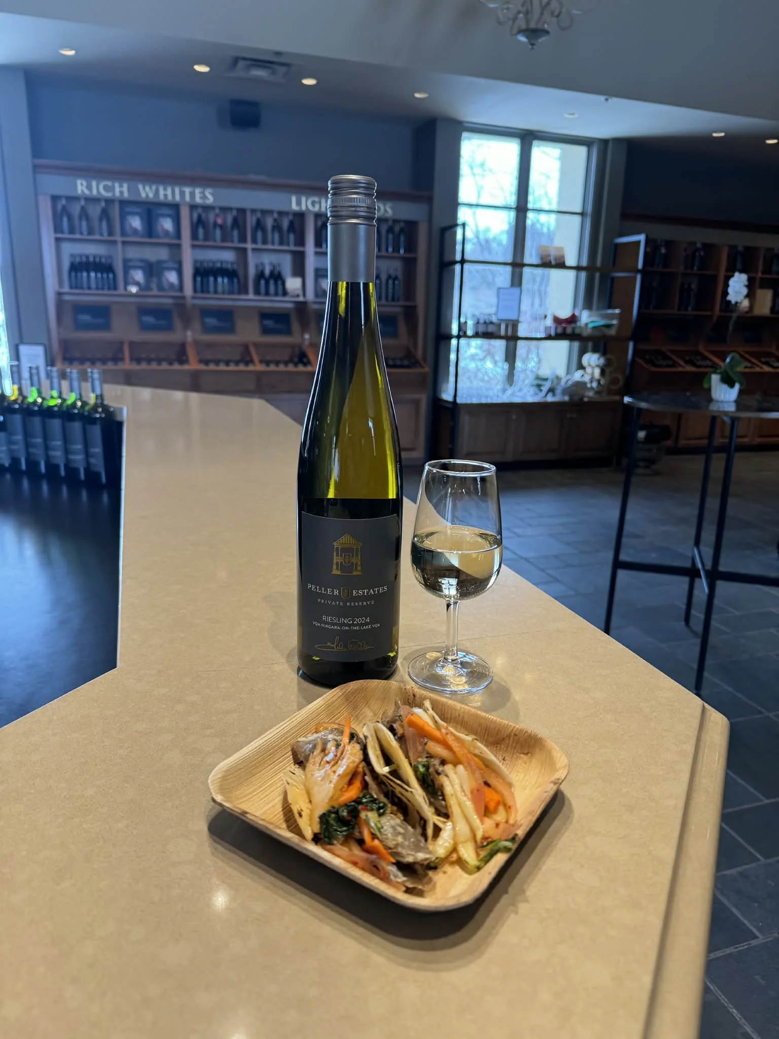 A plate of duck taco and a glass of Peller Estates Reserve Riesling