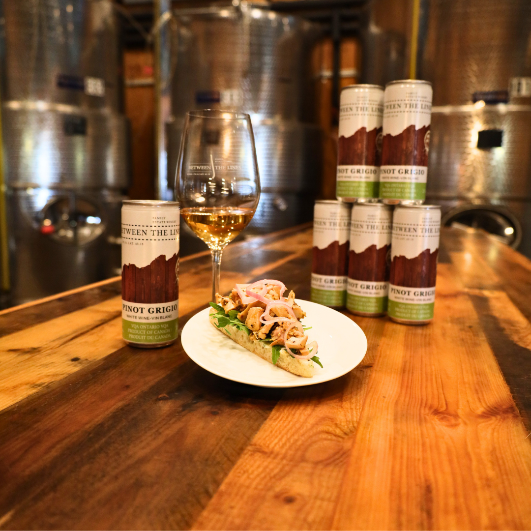 Grilled chicken and arugula on ciabatta with a glass of Between the Lines Pinto Grigio