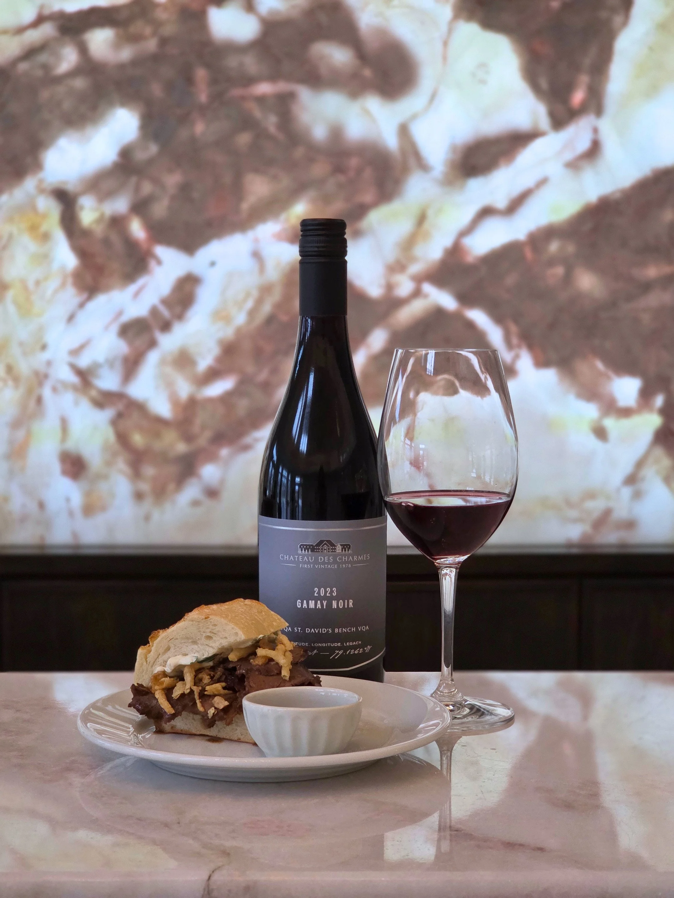 Canadian beef served on a French baguette with a glass of Chateau des Charmes Gamay Noir