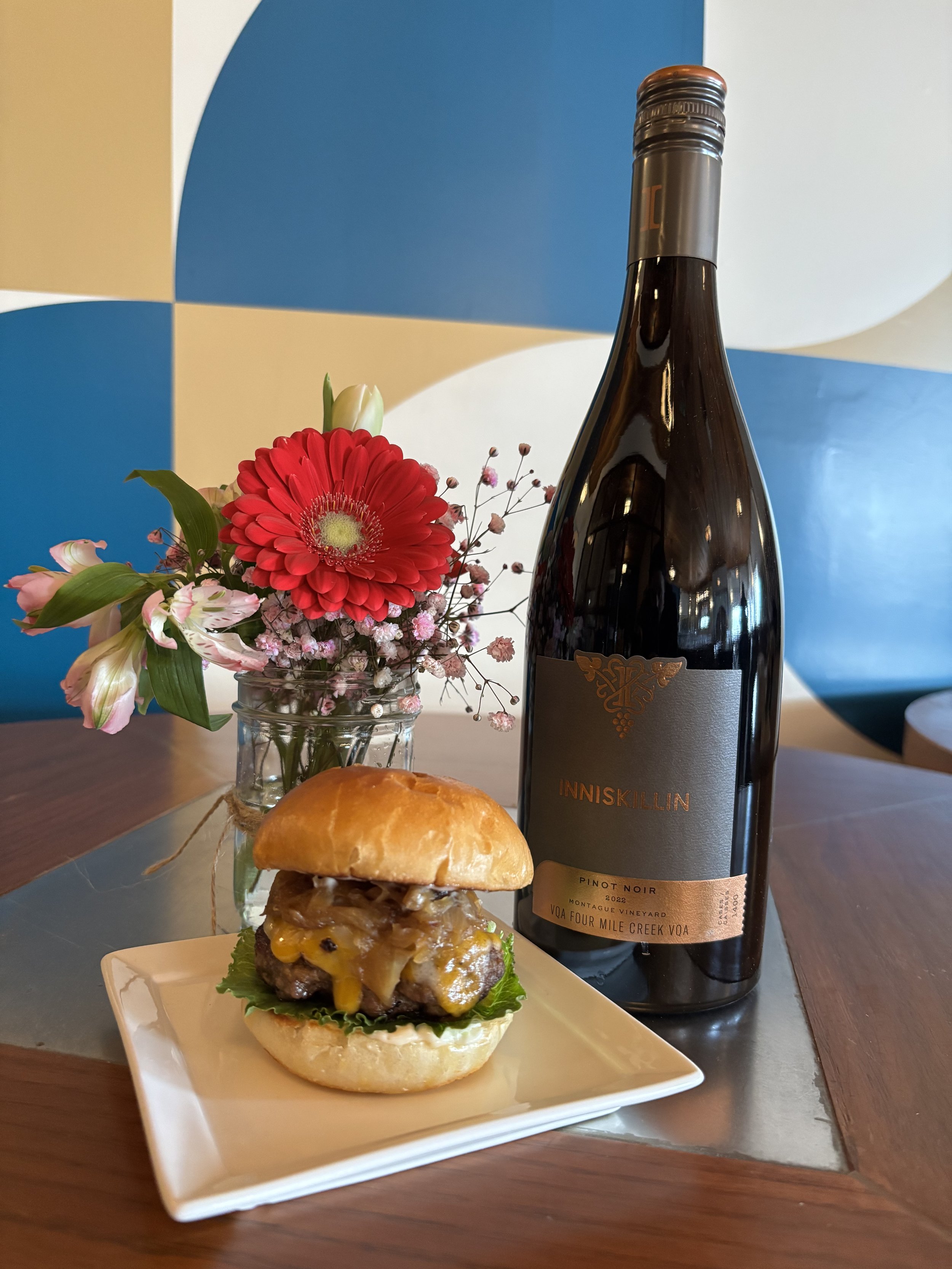 A beef brisket slider with a glass of Inniskillin Pinot Noir
