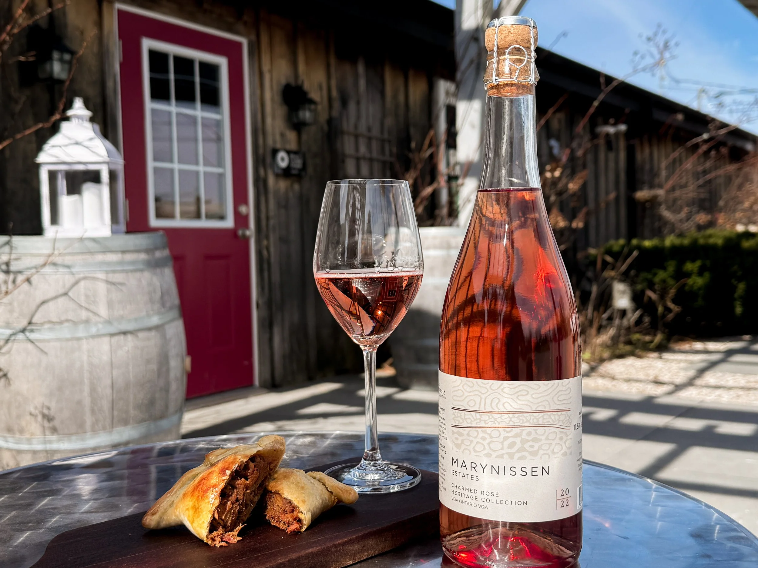 A pork empanada and a glass of Marynissen Estates 2022 sparkling Charmed Rose