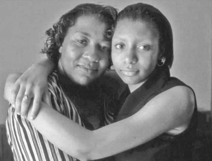 A black and white photo of two women embracing, showing a bond and emotional connection.