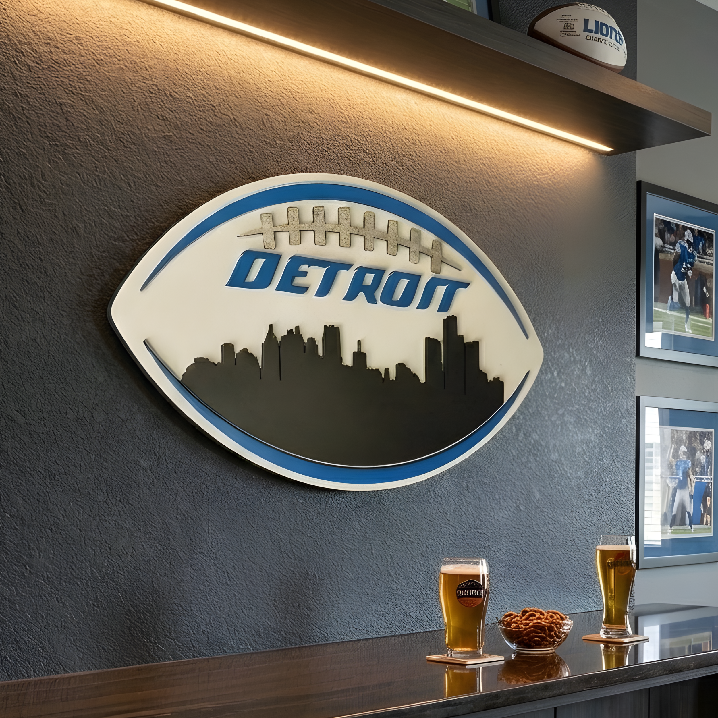 Close-up of a football-shaped Detroit skyline sign in blue and silver mounted above a home bar with two beers.