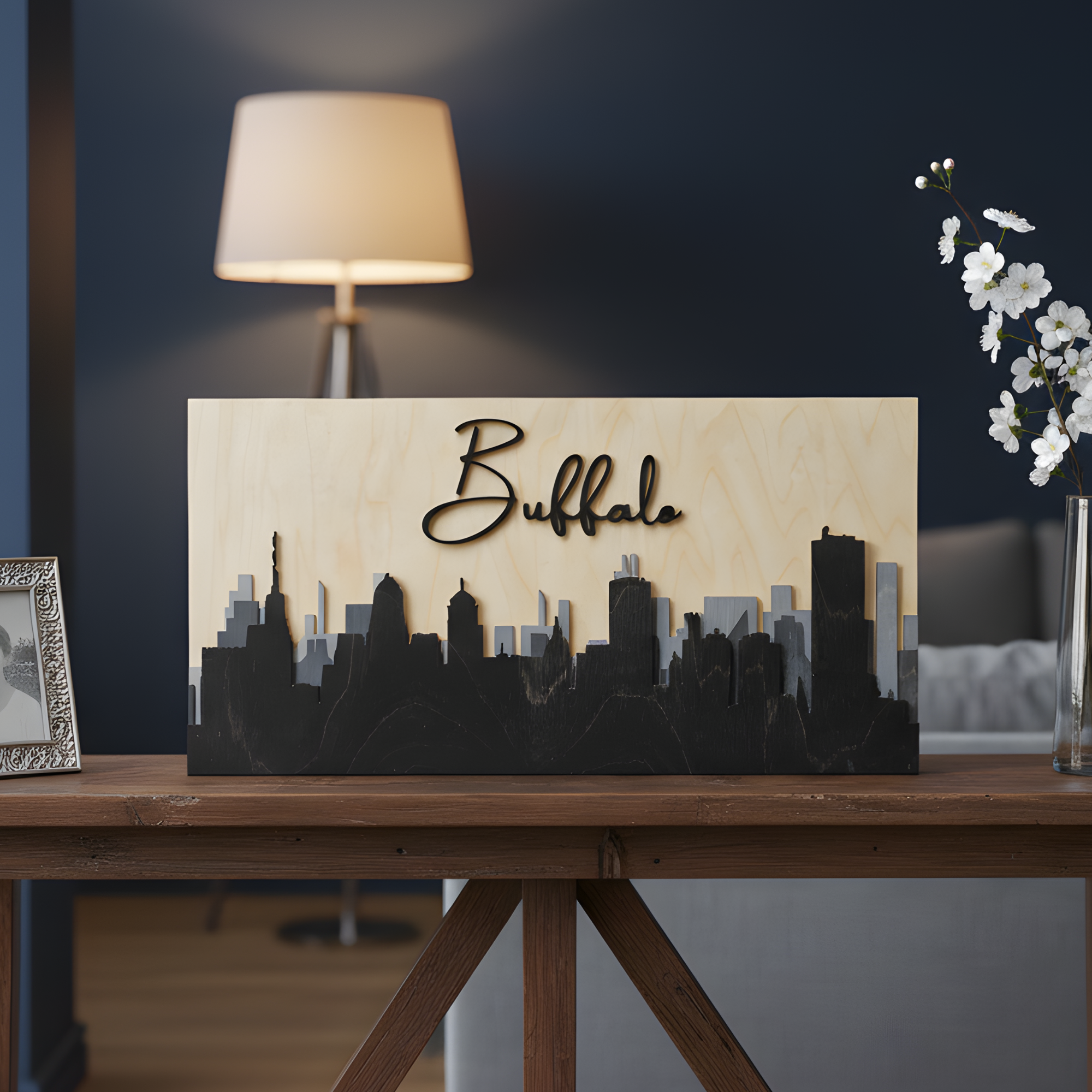 Handcrafted Buffalo skyline wood art in grey stain on a console table with modern home decor background.