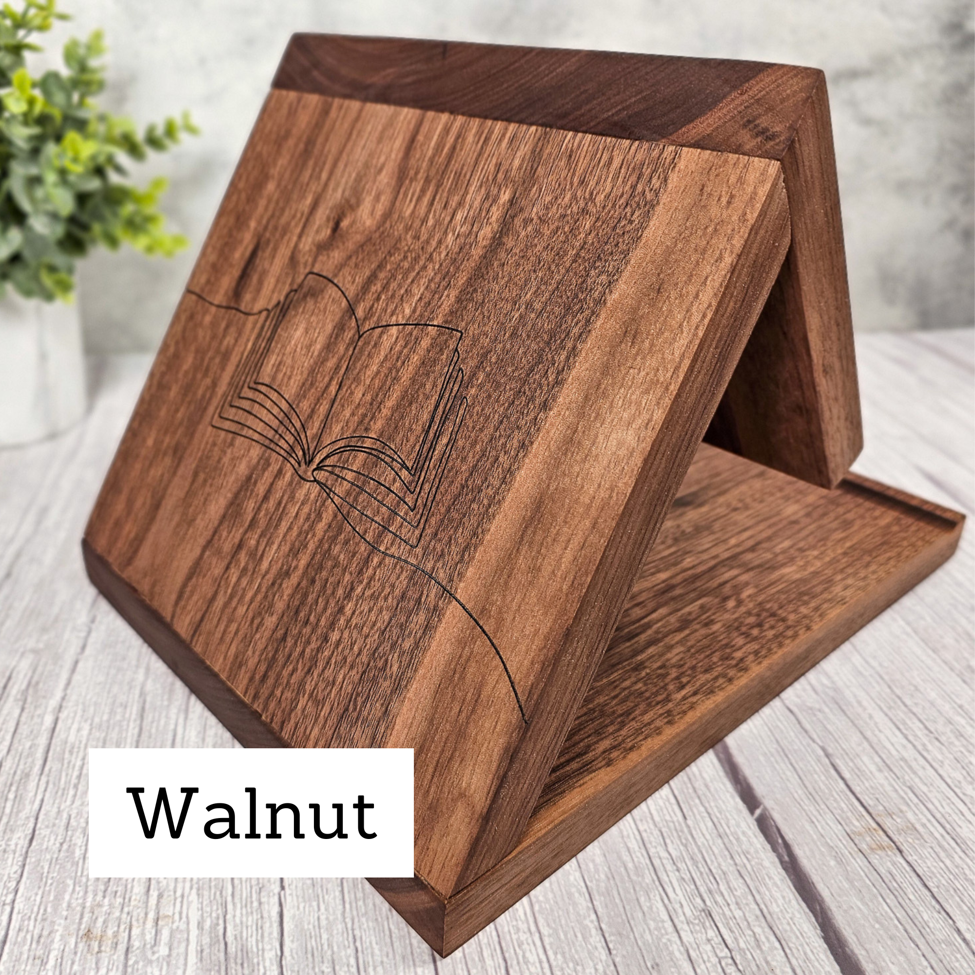 Handcrafted solid walnut book placeholder with a minimalist open book line drawing on the side.