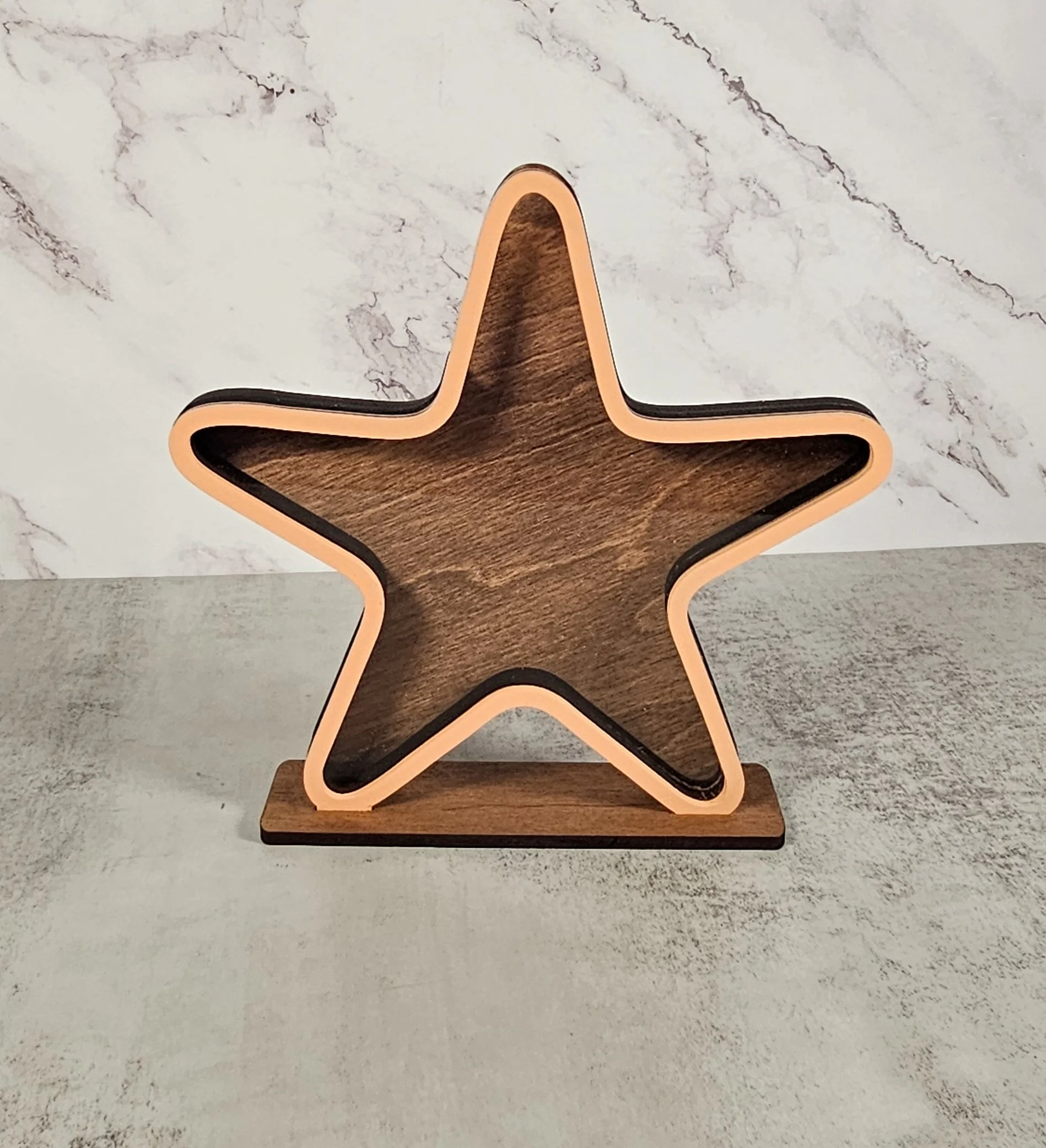 Starfish-shaped sea glass display box with a dark walnut backer.