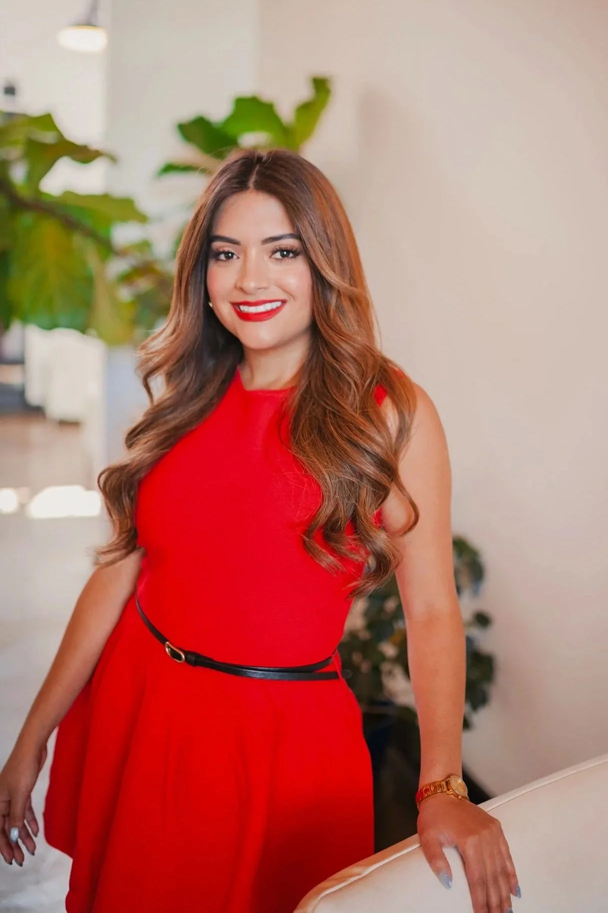 Person standing next to a red sign with "Sip Club", wearing a red top and blue jeans.