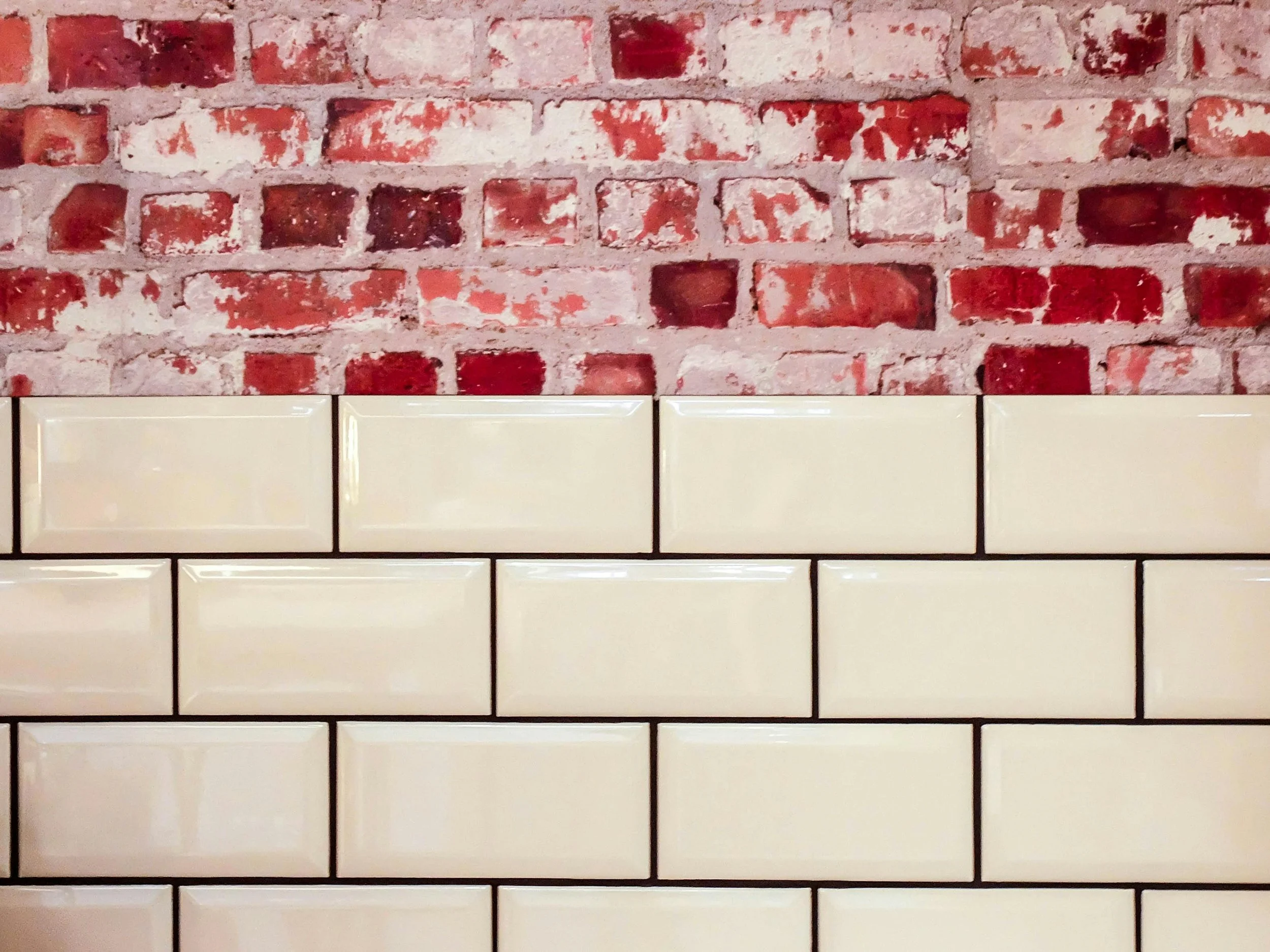 Exposed brick wall and cream subway tiles in Gravenhurst.