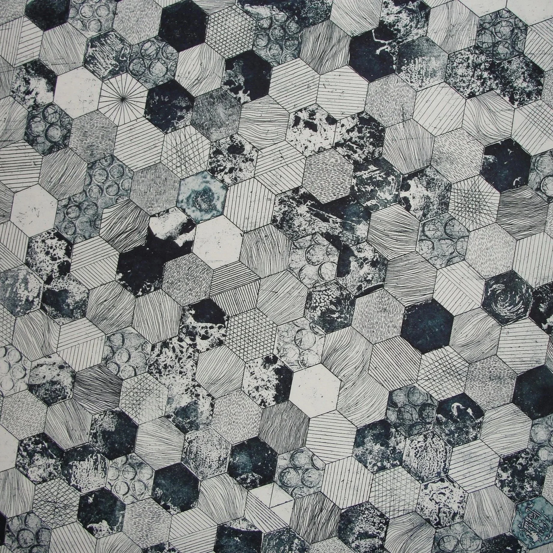 A black and white geometric pattern consisting of hexagons with various textures and designs, including lines, speckles, and abstract shapes.
