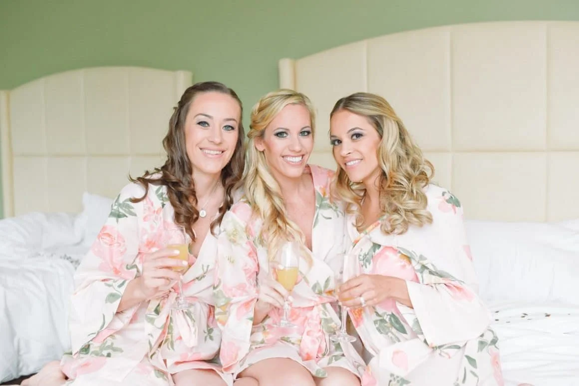 3 fabulous gals getting ready for the big day while enjoying some champagne