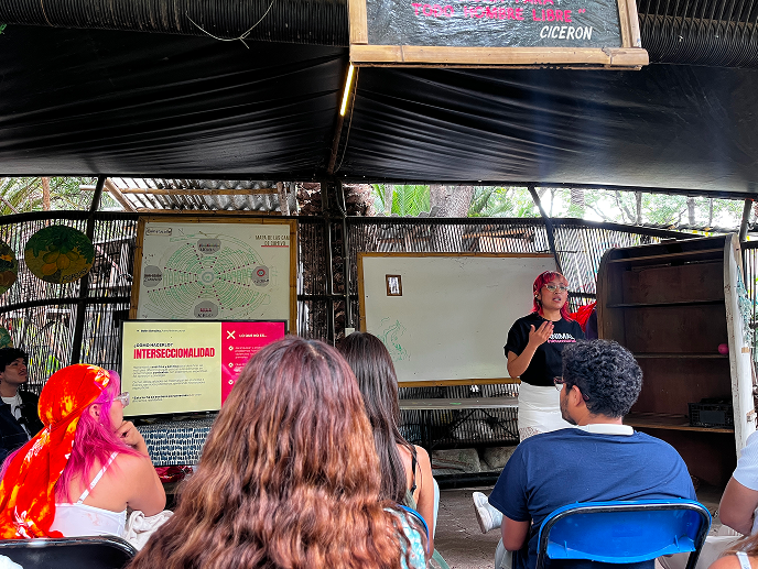 Person presenting in front of a crowd