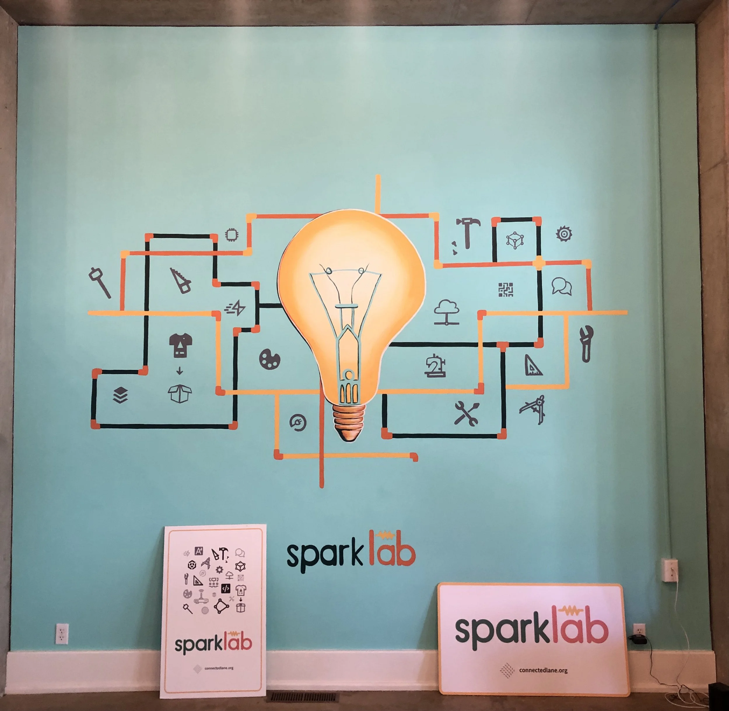 Spark Lab community makerspace mural with lightbulb and technology icons, Eugene Oregon, 2021, by Brynn Gerl