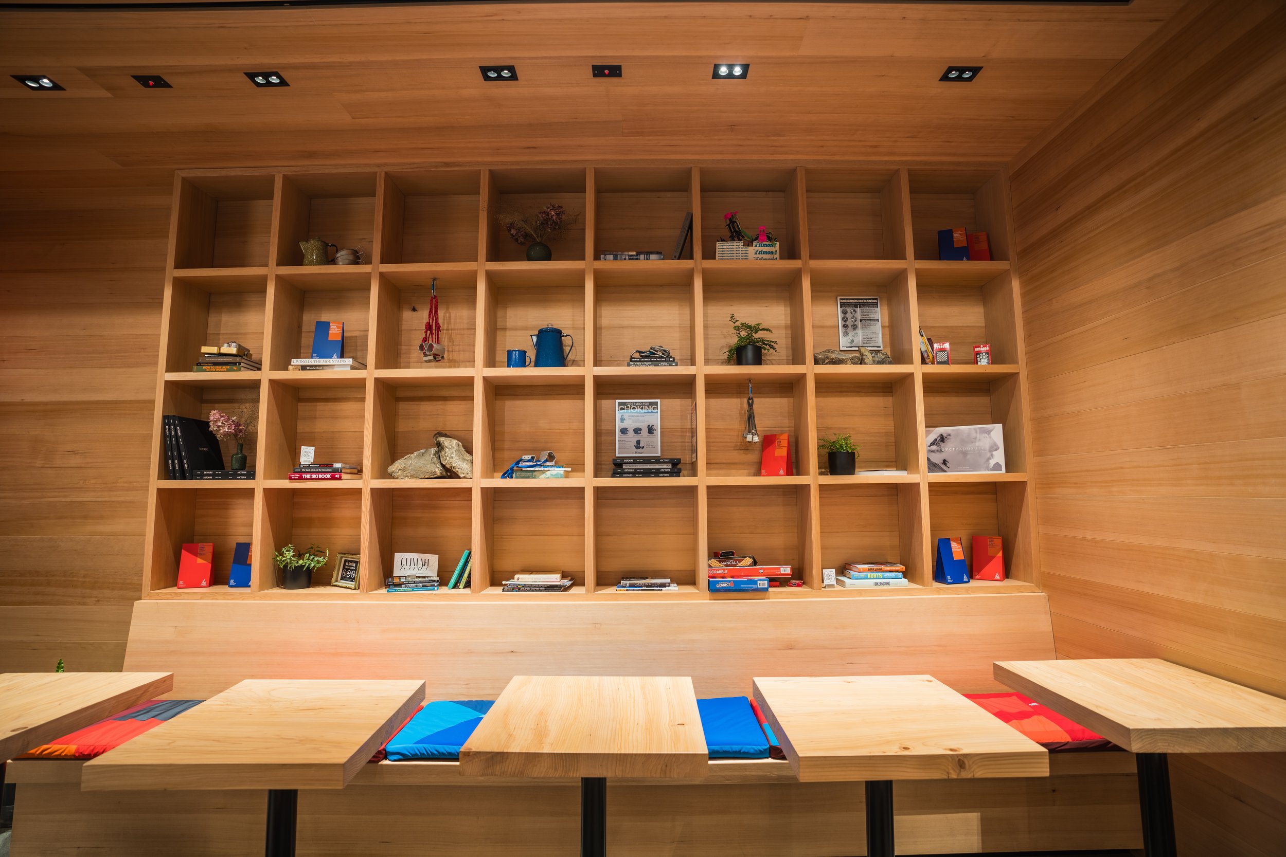 Modern wooden shelving with books, decorative items, and plants