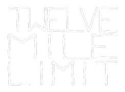 Handwritten sign reading 'Twelve Mile Limit' on a black background