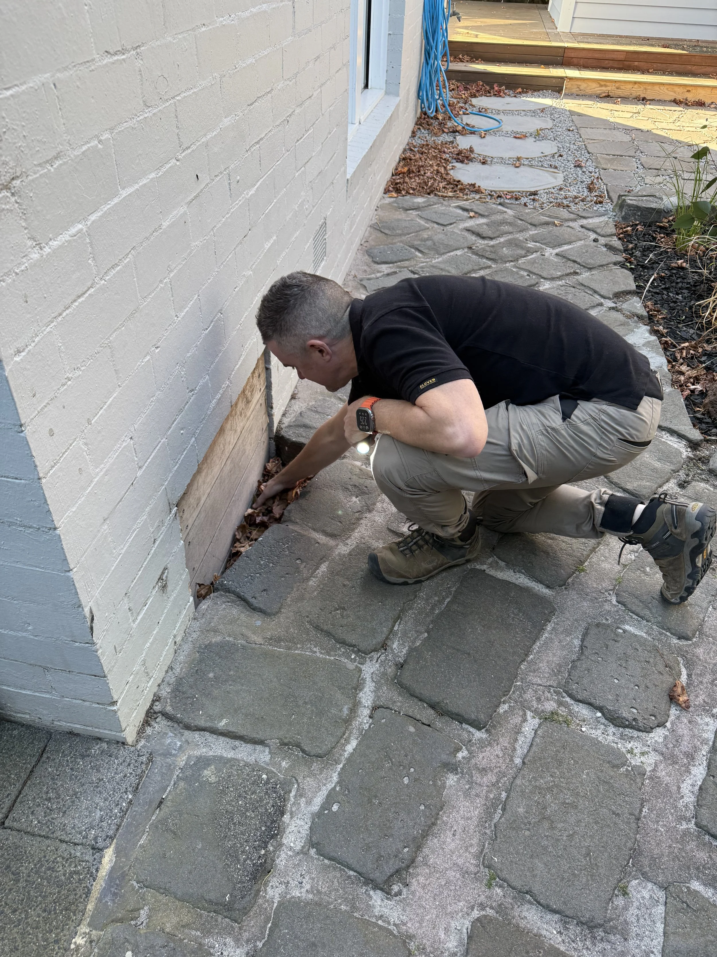 Darren inspecting a subfloor opening