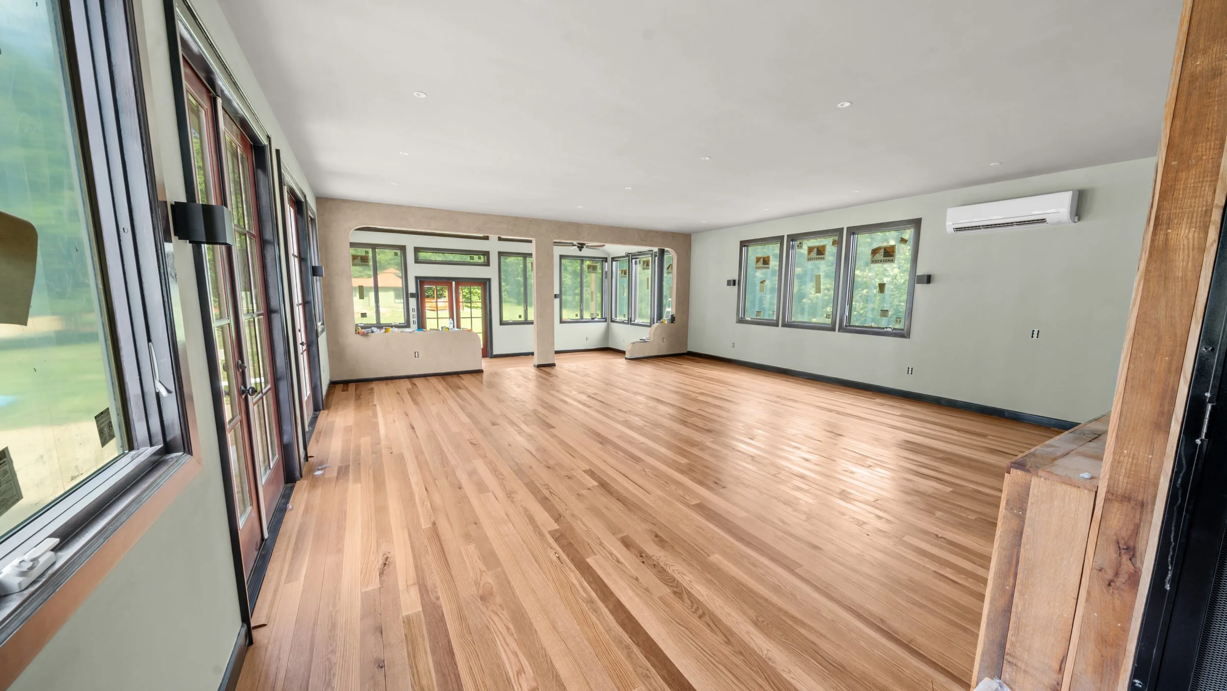 Bright sunroom addition with wide-plank oak flooring