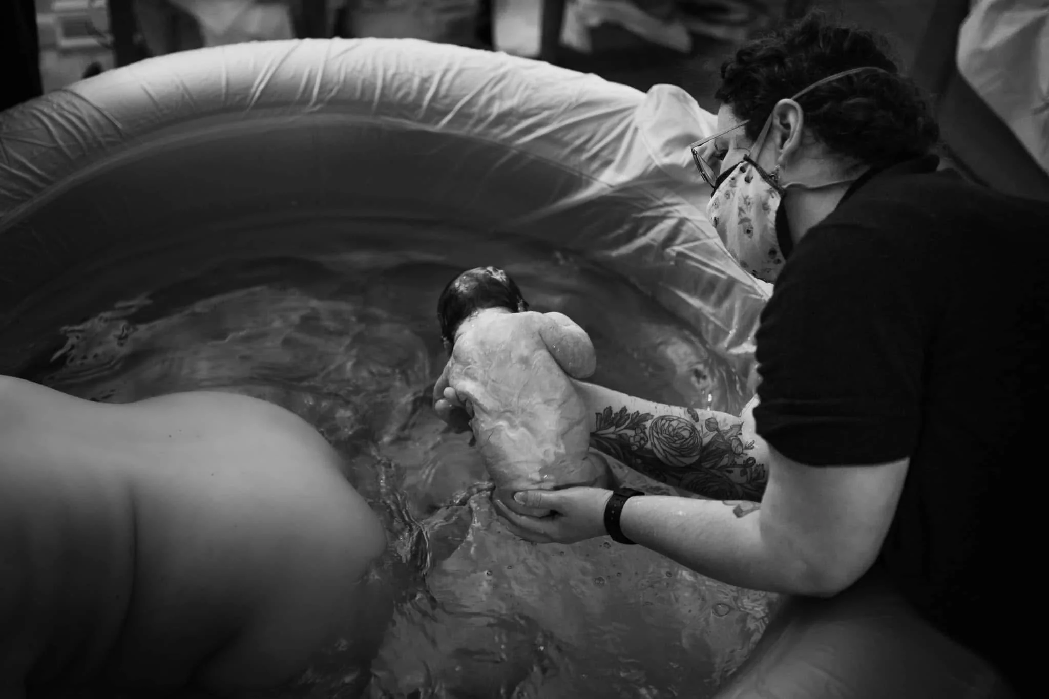 Midwife Noel Fernandez assists at a water birth.