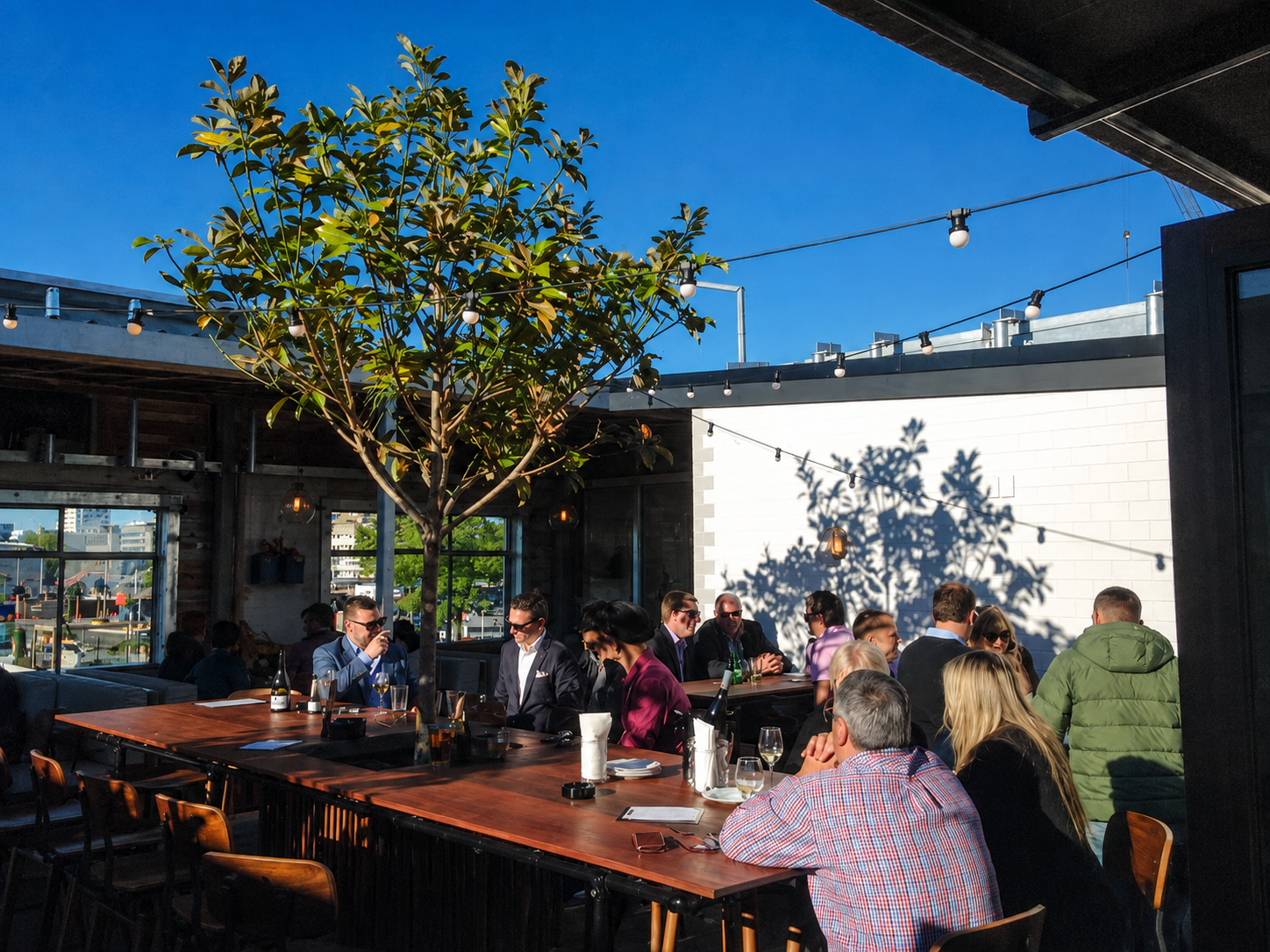 Guests enjoying drinks on the rooftop at Royals in Christchurch