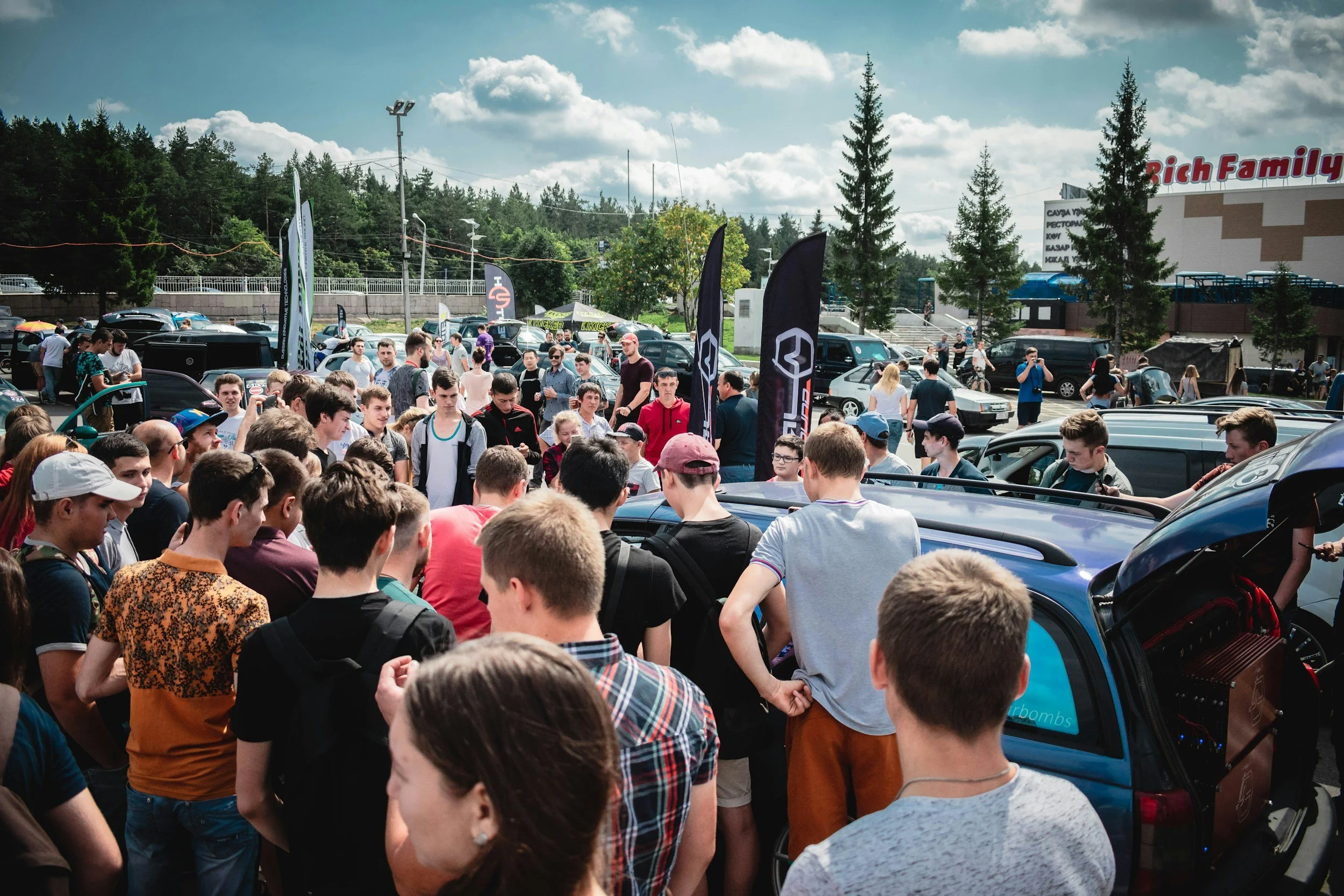 People gathered at cars and coffee event