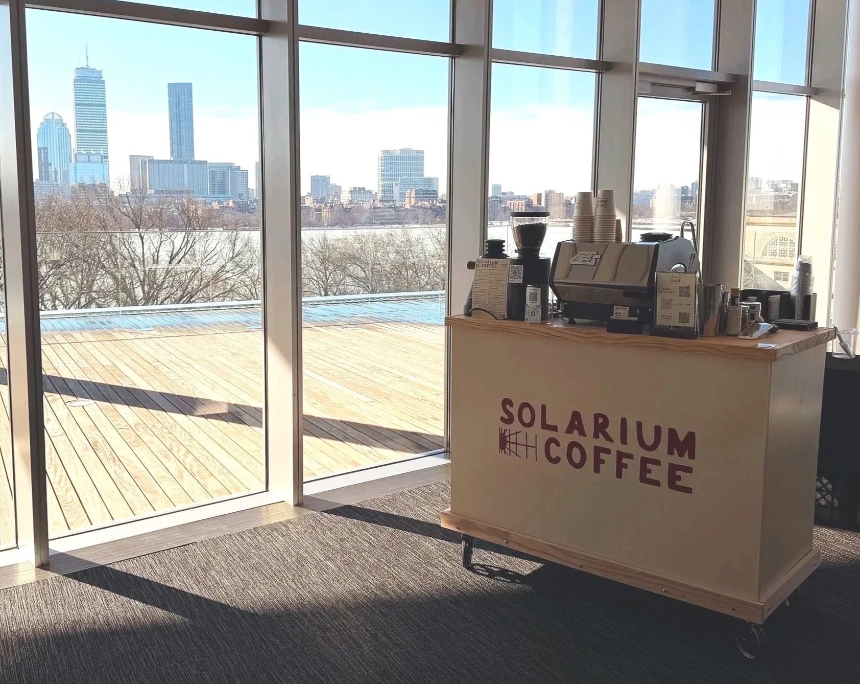 coffee cart at conference with Boston skyline in background
